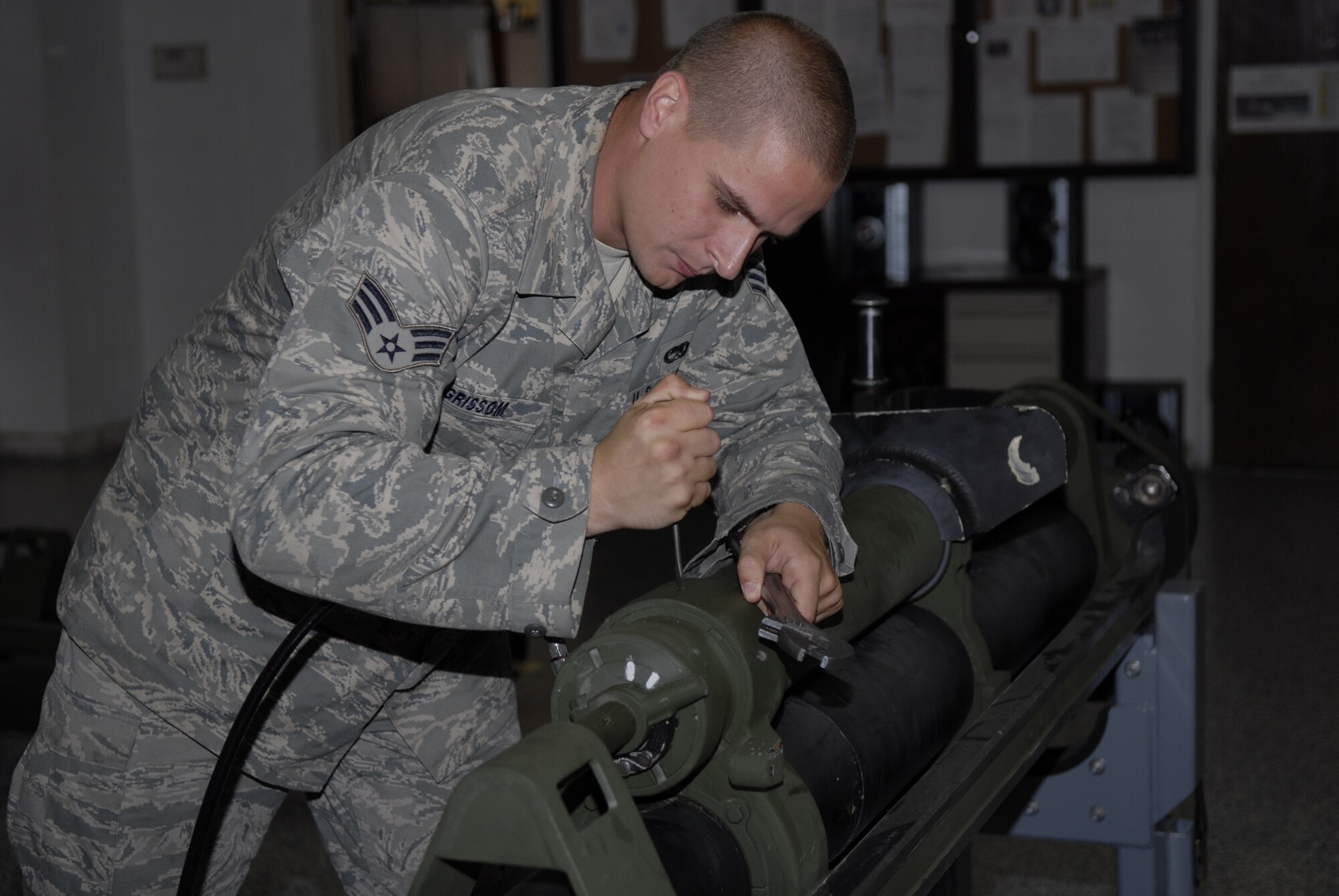 Senior Airman Tres Grissom, 1st Special Operations Equipment Maintenance Squadron armament team member, works on a 105 mm side rail assembly at the 1st SOEMS armament flight building at Hurlburt Field, Fla., June 8, 2010. Airman Girssom was selected for this week's "Tip of the Spear" spotlight. (DoD photo by U.S. Air Force Airman 1st Class Joe McFadden)