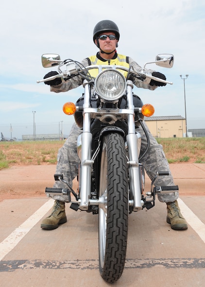 DYESS AIR FORCE BASE, Texas-- Senior Master Sgt. Phillip Boyes, 7th Aircraft Maintenance Squadron, dons the proper safety gear before riding his motorcycle June 7 here. 7th Bomb Wing Safety offers motorcycle safety foundation courses that consist of a basic rider course and an experienced rider course. For more information on motorcycle safety courses, call safety at (325) 696-5598. (U.S. Air Force photo/Airman 1st Class Brittney Smolinski) 