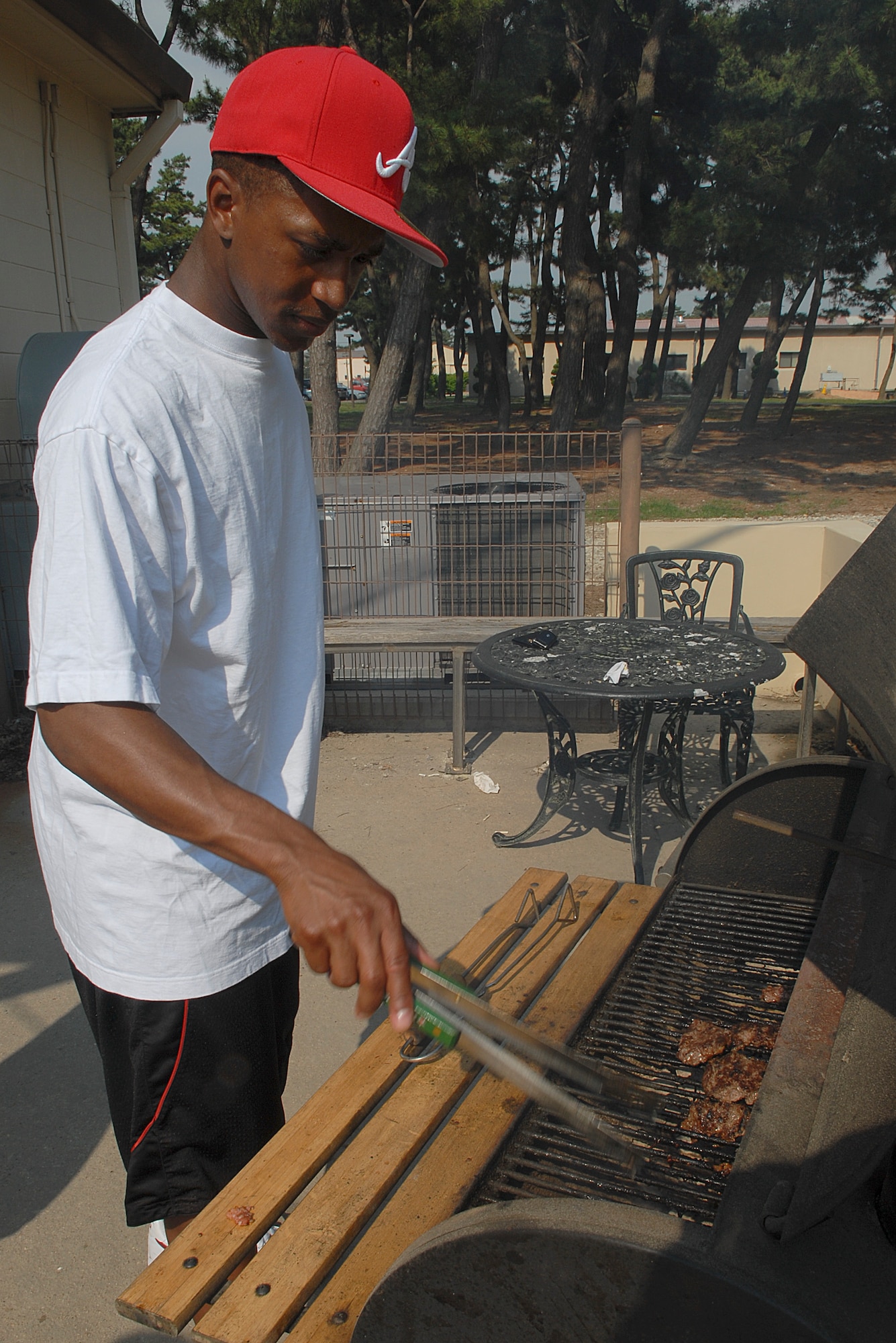 KUNSAN AIR BASE, Republic of Korea--Staff Sgt. Crayton Felder, 8th Civil Engineer Squadron, cooks hamburgers during an Airmen Committed to Excellence meeting June 8. While cooking on a grill Wolf Pack Airmen must follow proper safety guidelines. (U.S. Air Force photo/Senior Airman Roy Lynch)