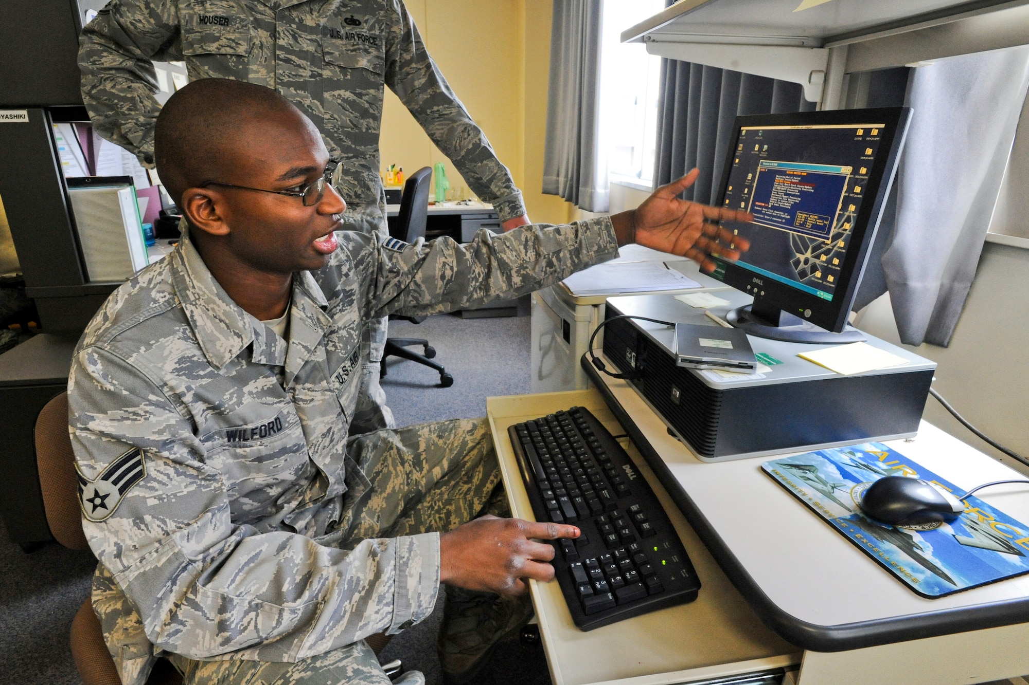 MISAWA AIR BASE, Japan -- Senior Airman Ladale Wilford, 35th Logistics Readiness Squadron vehicle management and analysis journeyman, explains the Online Vehicle Interactive Management System June 8 at the 35th LRS vehicle maintenance shop. OLVIMS is a vehicle-data collections system used to process new vehicles, order parts for repair, track vehicle accidents and manage maintenance requests. (U.S. Air Force photo/Senior Airman Jamal D. Sutter)