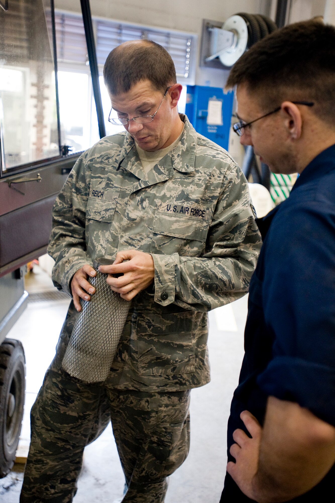 MISAWA AIR BASE, Japan -- Staff Sgt. Robert Reich, 35th Logistics Readiness Squadron vehicle maintenance journeyman, and Airman 1st Class James Nichols, 35th LRS vehicle maintenance apprentice, research air filters June 8 at the 35th LRS vehicle maintenance shop. Airman Nichols needed the correct air filter to perform an annual, scheduled vehicle inspection. (U.S. Air Force photo/Senior Airman Jamal D. Sutter)