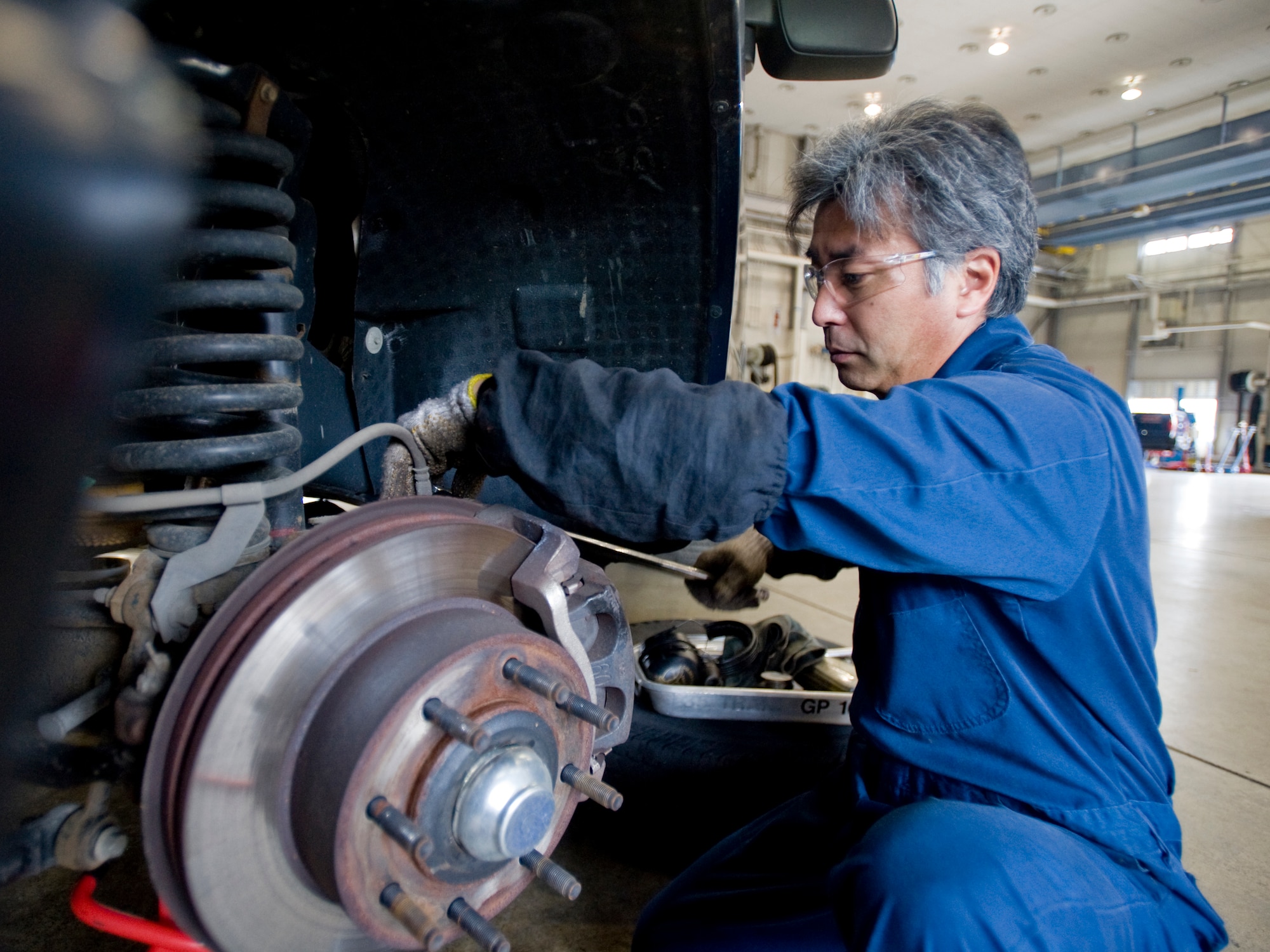 MISAWA AIR BASE, Japan -- Kitamuki Hiromitsu, 35th Logistics Readiness Squadron general-purpose mechanic, repacks wheel bearing for a pick-up truck June 8 at the 35th LRS vehicle maintenance shop. Mr. Hiromitsu performs repairs, diagnostics and component rebuilds to government vehicles assigned to the 35th LRS fleet. (U.S. Air Force photo/Senior Airman Jamal D. Sutter)
