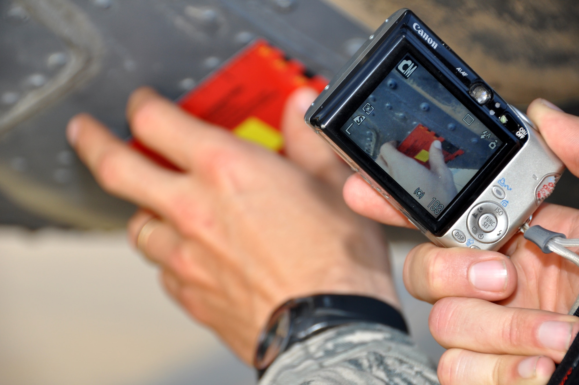 The Joint Combat Assessment Team uses many tools to assess small arms fire to U.S. aircraft. Here, Capt. Mark Friesen uses the JCAT square to measure the size of a bullet hole on an HH-60G Pave Hawk. (U.S. Air Force photo by Tech. Sgt. Renni Thornton)
