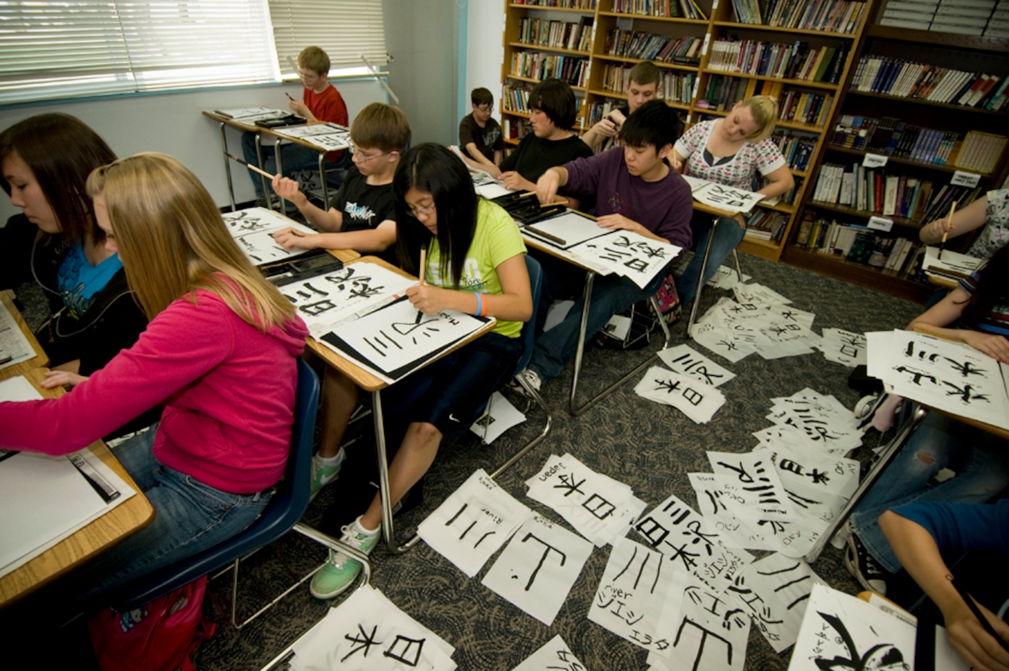 Edgren High School students use ink-dipped brushs on thin paper to create Japanese kana characters during a shodo calligraphy lesson at their school’s Intercultural Education class, June 3. Sensei Koki Takahachi, who offers Japanese calligraphy classes at the Mokuteki Community Center, brought materials for each student to practice writing several well-known characters found on Misawa City signs. (U.S Air Force photo/ Senior Airman Jessica Lockoski)