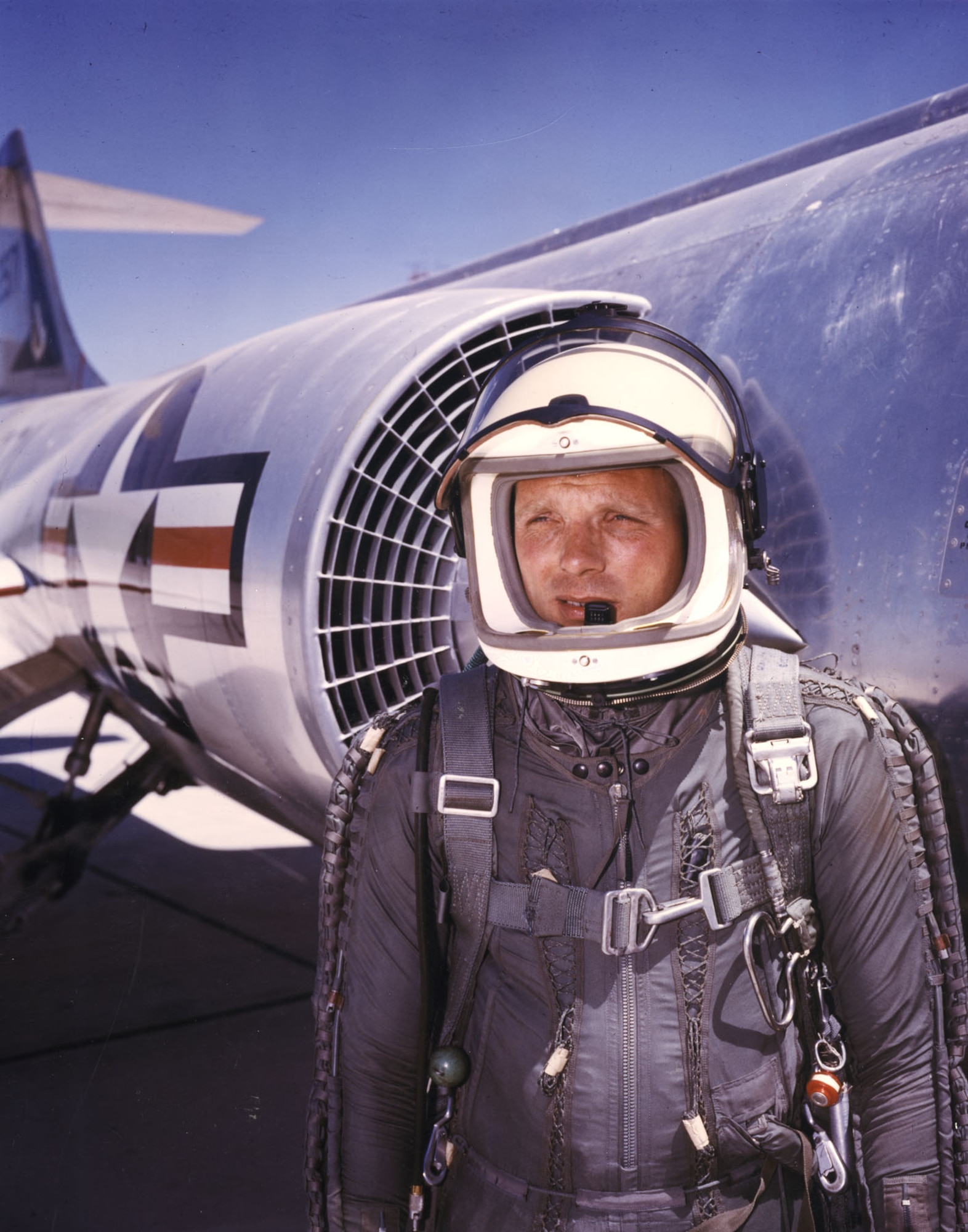 Wearing a high-altitude partial pressure suit, Capt. Iven C. Kincheloe Jr. poses beside an F-104, the type of plane he was flying when he was killed. (U.S. Air Force photo)
