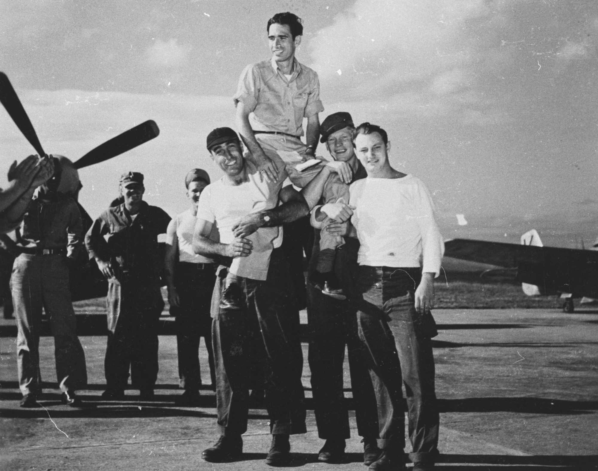 Groundcrewmen carry Col. Dean Hess from his plane upon completing his 100th Korean combat mission. (U.S. Air Force photo)