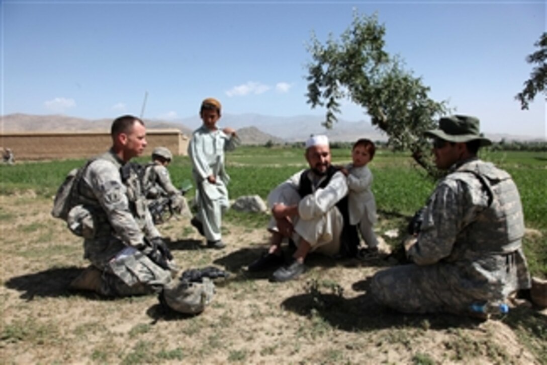 U.S. Army 1st Lt. Kevin Sweet (left), the platoon leader of the 3rd Platoon, Legion Company, 1st Battalion, 503rd Infantry Regiment, 173rd Airborne Brigade Combat Team, and an interpreter speak with an Afghan man in the village of Ibrahimkhel in the Nerkh district of the Wardak province of Afghanistan on May 27, 2010.  