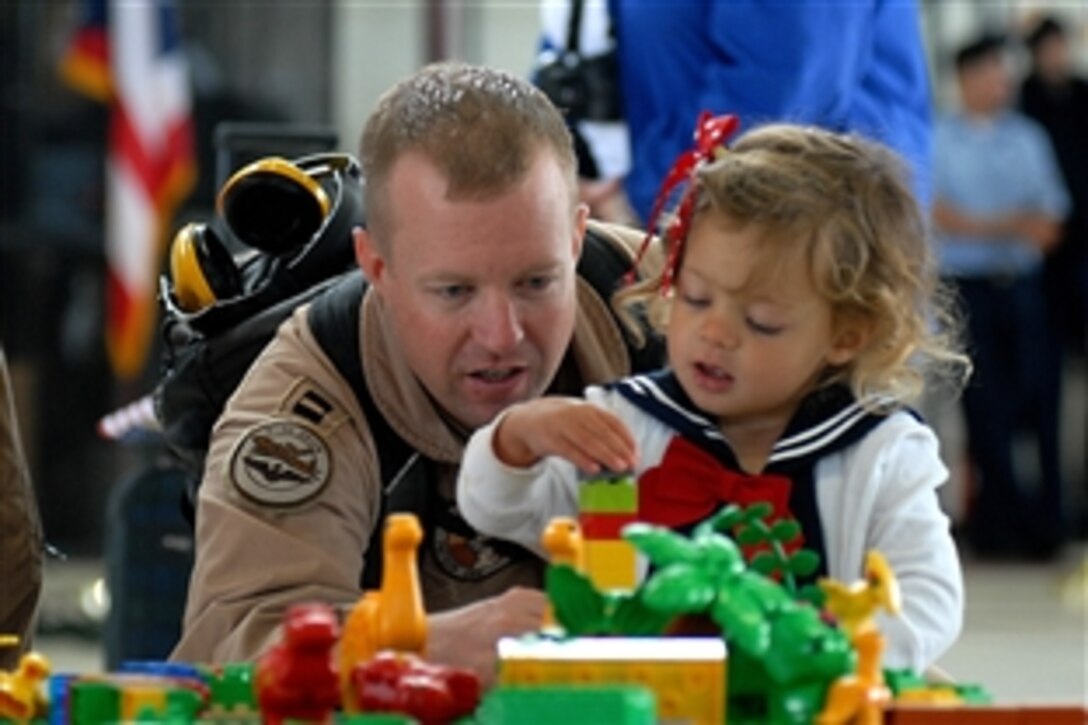 U.S. Navy Lt. John Graham plays with his daughter during a homecoming on  Naval Air Station Whidbey Island, Wash., June 7, 2010. Graham is assigned to the Screaming Eagles of Patrol Squadron 1, which just returned from a six-month deployment.
