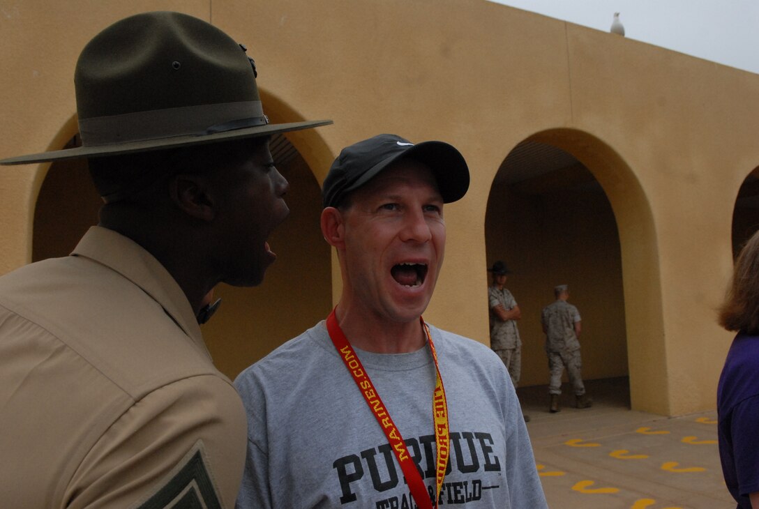 Richard Button, Spanish teacher, Plymouth High School, Plymouth, Ind., replies with an "aye aye sir!" after being corrected by Sgt. Antoriano Smith, Drill Instructor, 2nd Battalion, Company E, shortly after arriving on the yellow footprints.