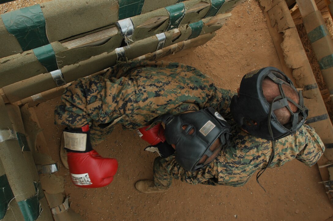Recruits Sebastian Santos, left, and Grant Springer, right, Platoon 3215, go for each other’s kidneys as their one minute bout became up close and chaotic during the Crucible. Even if a recruit has no fight experience, winning will come down to who wants it more.