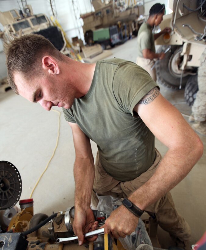 Lance Cpl. Andrew C. Adams, 26, from Fort Worth, Texas, motor transport mechanic with Maintenance Company, Combat Logistics Regiment 15 (Forward), 1st Marine Logistics Group (Forward), repairs a Mine-Resistant Ambush Protected vehicle at the Intermediate Maintenance Activities lot at Camp Leatherneck, Afghanistan, May 21. MRAPs can cost up to $1 million, and the mechanics are able to fix a vehicle damaged by an IED within a few weeks, depending on damage sustained, saving time and money for the Marine Corps.