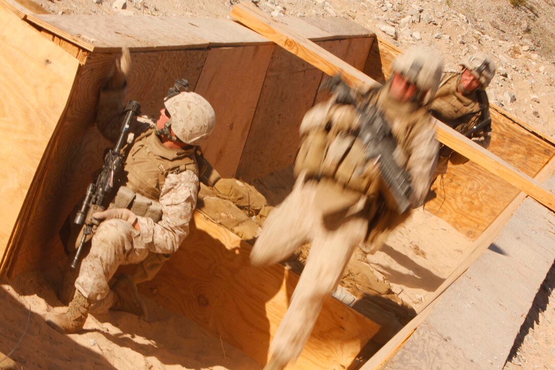 Marines with Company D, 3rd Light Armored Reconnaissance Battalion rush through one of several trenches June 9 at Combat Center Range 410. The range was meant to refine dismounted scout and light armored vehicle integration tactics. ::r::::n::