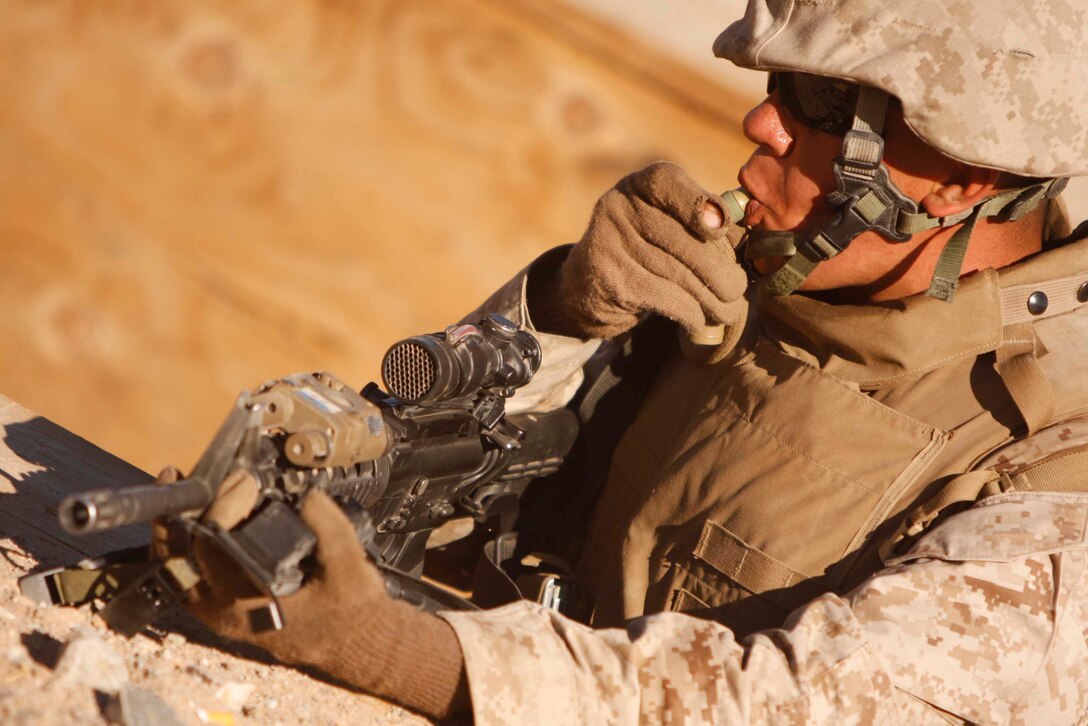 Lance Cpl. Anthony Sgarlata, a mortarman attached to Company D, 3rd Light Armored Reconnaissance Battalion, hydrates after running Range 410 June 9. The Marines of the company practiced basic platoon attacks at the range June 9 to 11. ::r::::n::