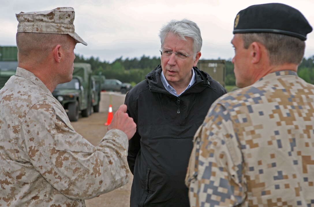 Latvian Minister of Defense Imants Liegis (center), and Maj. Gen. Juris Maklakovs (right), the Commander of National Armed Forces of Latvia, listen as Lt. Col. James. C. McDonald, commanding officer of 4th Landing Support Battalion, provides them with an overview of what the Navy and Marine Corps participants in exercise BALTIC OPERATIONS 2010 are doing at the logistics support area here. The Minister of Defense and Chief of Defense visited several sights in the Ventspils area where U.S. and Latvian forces are working together to conduct a maritime preposition offload exercise.
