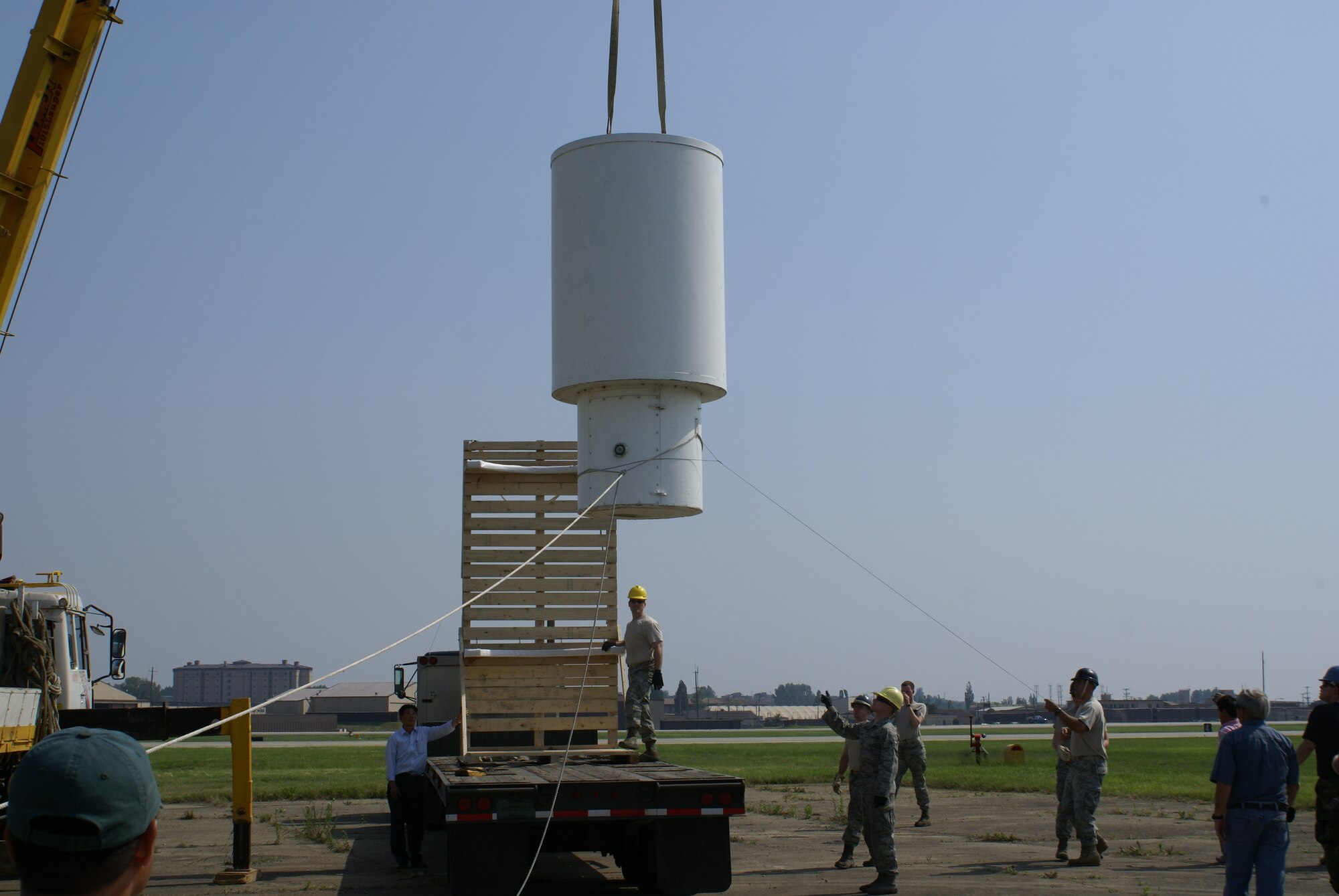 Staff Sgt. Jason Hall and Airman 1st Class Steven Kohut, 51st Communications Squadron, ensure proper placement of the Tactical Air Navigation System, or TACAN, antenna on the trailer for shipping at Osan Air Base, Republic of Korea, June 4. The antenna was part of the Very High Omni-Range/Tactical Air Navigation System, or VORTAC, used to guide pilots safely to the airfield for approach in adverse weather conditions. The VORTAC was recently decommissioned as a new system was installed and control was turned over to the Republic of Korea Air Force. (Courtesy photo)
