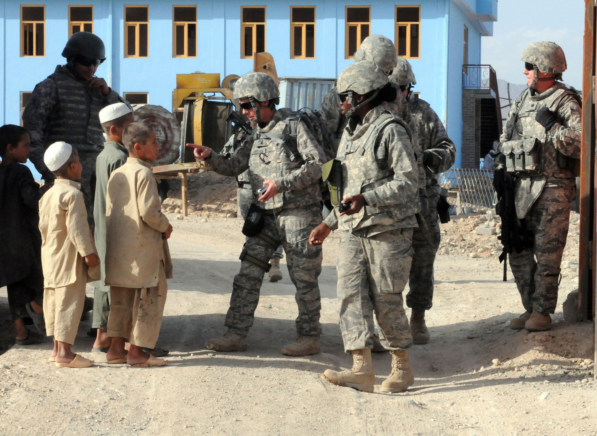 TRAVIS AIR FORCE BASE, Calif. -- Capt. Susan Labrecque, executive office with the 349th Air Mobility Wing here, attempts to communicate with local Afghani children as she and her team go about their duties in their deployed location. She is deployed for six months, assigned to the 755th Air Expeditionary Group, Bagram Air Base, Afghanistan. (Courtesy photo) 