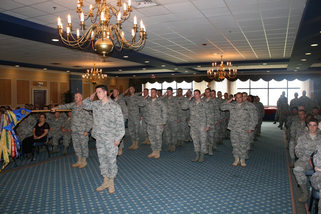 Airmen of the 30th Intelligence Squadron render a salute to incoming commander Lt. Col. James Mock at a change of command ceremony June 9 in the enlisted club at Langley Air Force Base, Va. Colonel Mock told the squadron that he felt honored and privileged to be their commander and looks forward to future challenges. Colonel Mock's previous assignment was at U.S. Central Command. (U.S. Air Force photo by Tech. Sgt. Joshua Ward)