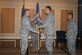 Lt. Col. James Mock, center, incoming 30th Intelligence Squadron commander, receives the squadron guidon from Col. Mark Cooter, left, 497th Intelligence, Surveillance and Reconnaissance Group commander, while outgoing commander Lt. Col. Brendan Harris, right, looks on at a change of command ceremony June 9 in the enlisted club at Langley Air Force Base, Va. (U.S. Air Force photo by Technical Sgt. Joshua Ward)