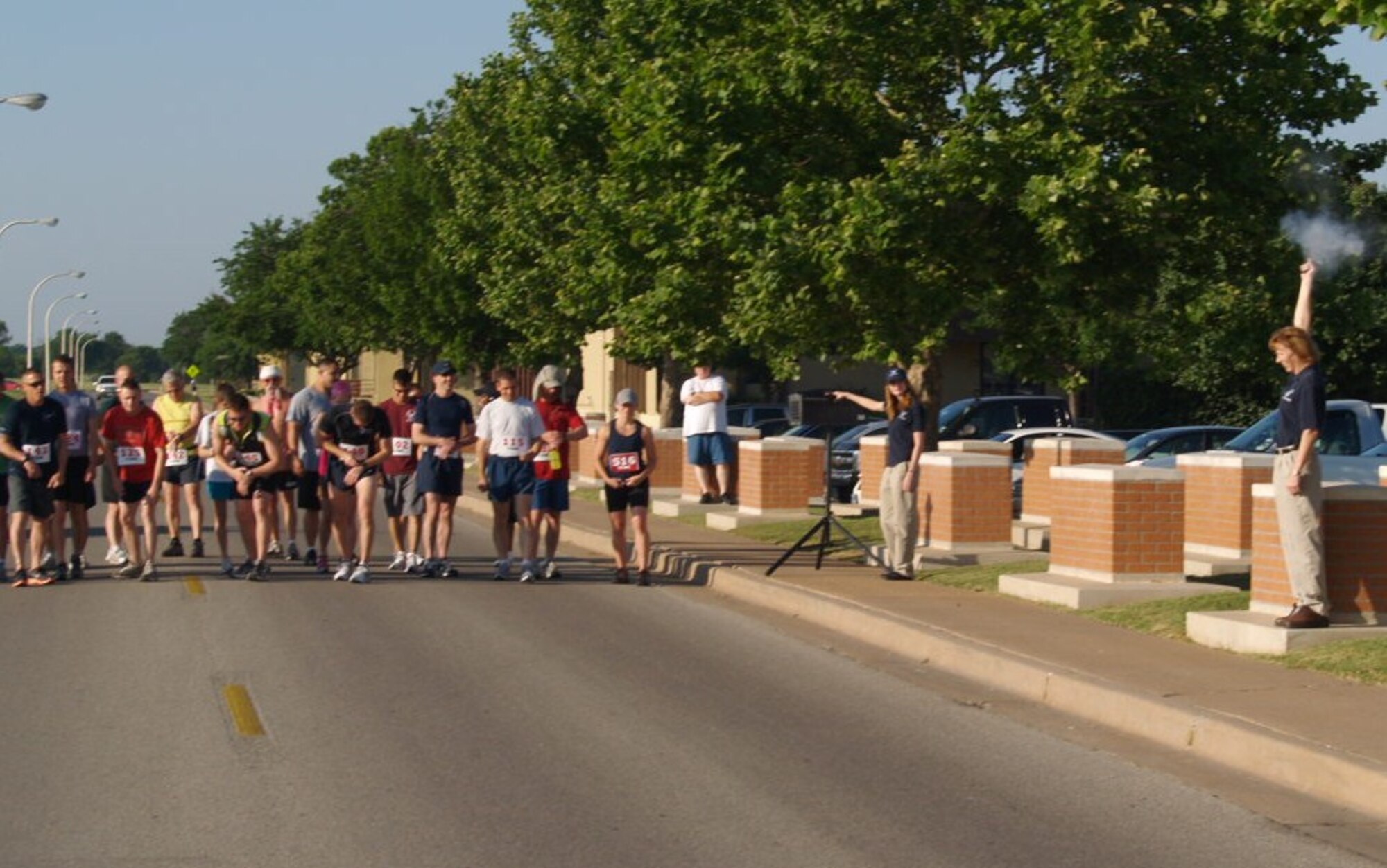 Sound of the starting gun, runners take their first steps in the half marathon held June 5, 2010 near the one-mile track at Sheppard Air Force Base, Texas. The 24 participants ran 13.5 miles in the half marathon and the three best male and female runners were rewarded with plaques. Beginning with the females in order of the fastest completion times were 1st Lt. Erin Fitzpatrick, Senior Airman Alycia McCollum and Staff Sgt. Monica Herrera. The male awardees in order of fastest completion time were Maj. Torsten Buehn, Capt. Jeff Carter and Airman Shawn Watters. (U.S. Air Force Photo/Brian Eskew)