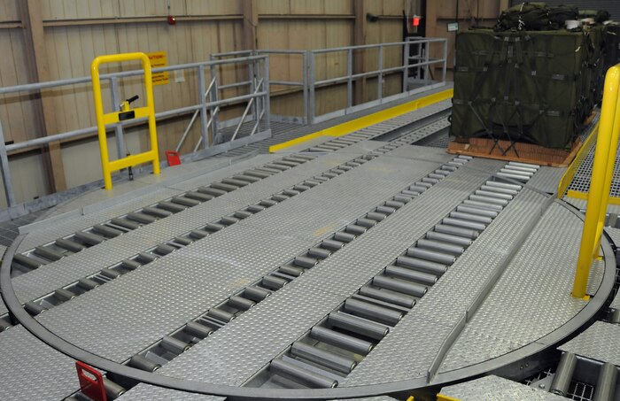 Stage five: Large turntables were installed to act as valves, allowing workers to direct bundles in the proper direction for loading and storage. They are spun either left or right with simple pull or push of their handles. (U.S. Air Force photo/Staff Sgt. Daniel Bowles)