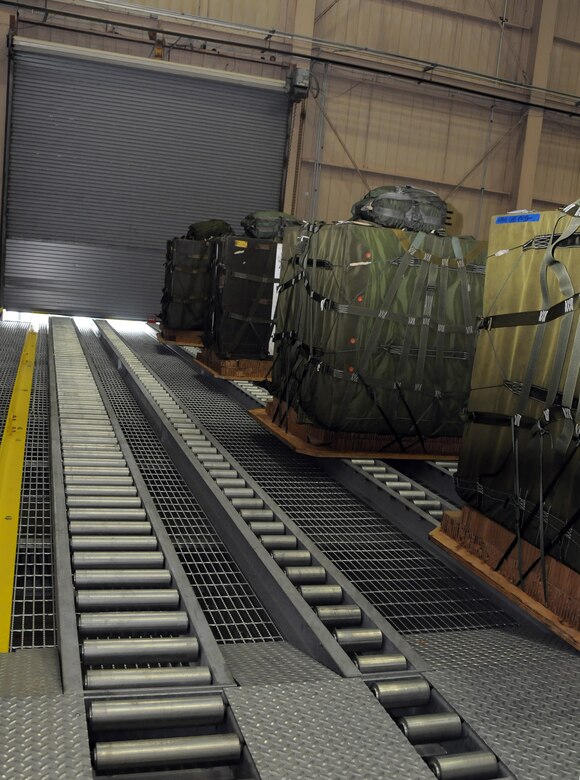 Stage six: The bundles reach the end of the road in this position on the final platform. After reaching the end position, they are ready to be quickly loaded onto aircraft cargo loading vehicles for aerial delivery training missions. (U.S. Air Force photo/Staff Sgt. Daniel Bowles)