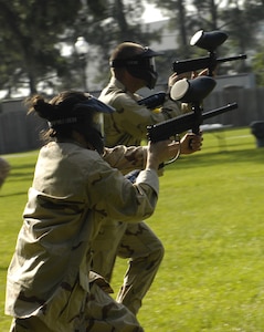 Airmen rush forward at the beginning of the paintball tournament at the base picnic grounds on Joint Base Charleston, S.C., June 4, 2010. The tournament was held as this month's Commander's Fitness Challenge and included eight different teams. (U.S. Air Force Photo/Airman 1st Class Lauren Main)