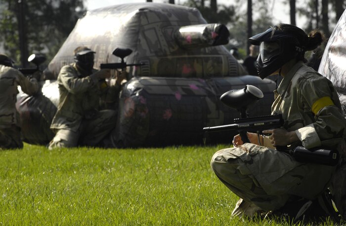 Airmen take cover from flying paintballs during a tournament at the base picnic grounds on Joint Base Charleston, S.C., June 4, 2010. The tournament was held as this month's Commander's Fitness Challenge and included eight different teams. (U.S. Air Force Photo/Airman 1st Class Lauren Main)