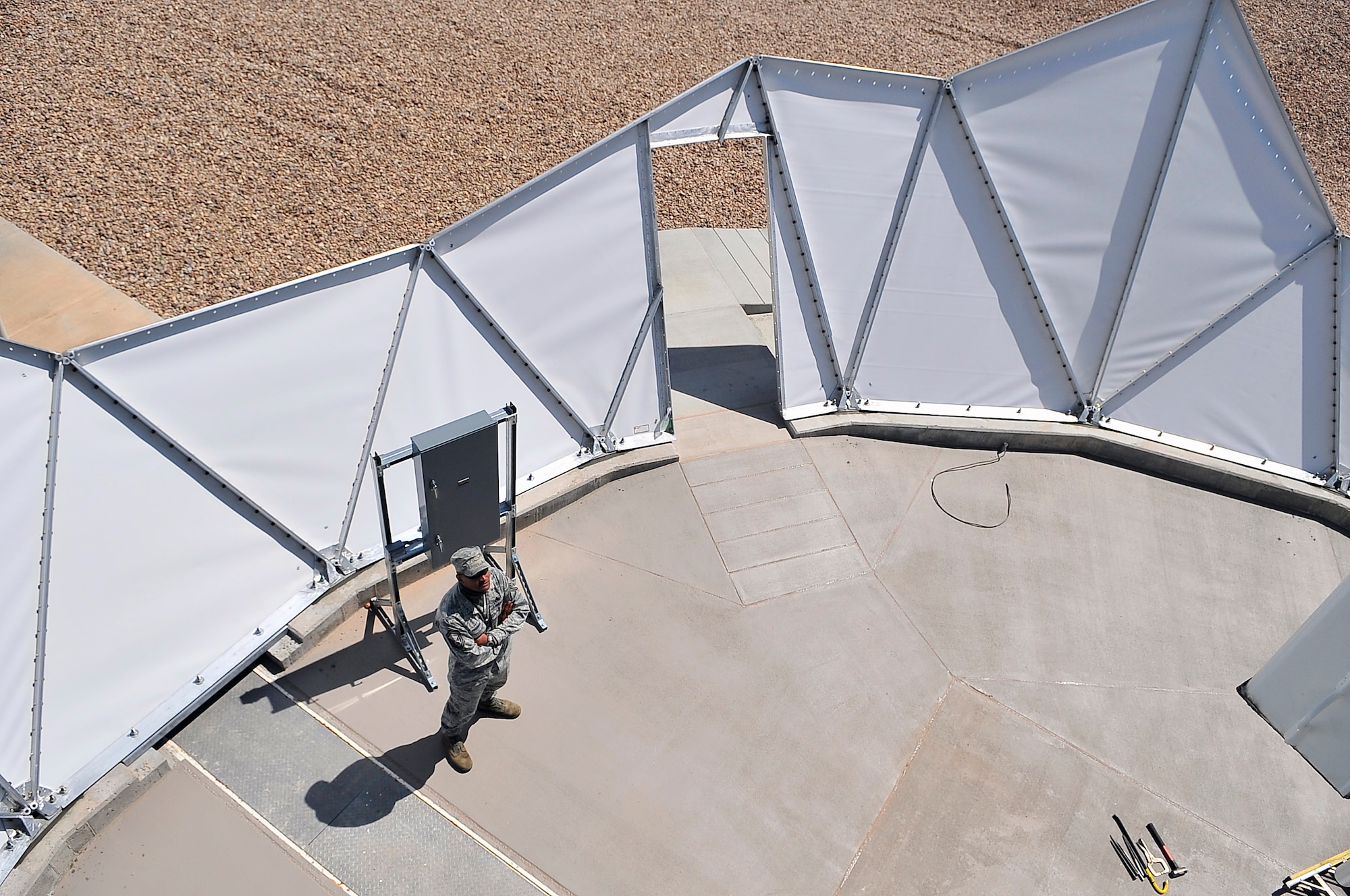 BUCKLEY AIR FORCE BASE, Colo. --  Senior Master Sgt. Michael Freeman, 460th Space Communications Squadron mission systems superintendent, does a final site survey before the installation of a radome enclosure here June 9. The enclosures protect Buckley assets from ice, snow and hail during winter weather. (U.S. Air Force photo by Staff Sgt. Kathrine McDowell)