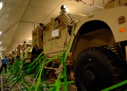 Contractors with Atlas Air secure mine-resistant, ambush-protected all-terrain vehicles onto a Boeing 747-400 on the flightline June 6, 2010, on Joint Base Charleston, S.C. The Boeing 747-400 carried the last of the 2,500 M-ATVs being shipped from Charleston to the Middle East to aid troops. (U.S. Air Force photo/Senior Airman Timothy Taylor)