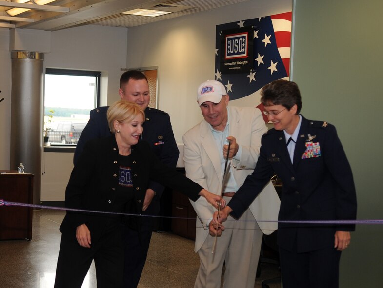 JOINT BASE ANDREWS, MD.-Colonel Jacqueline Van Ovost, 89 AW commander, Ms. Elaine B. Rogers (left), USO of metropolitan Washington president, and Mr. John Marselle (center), chairman of the board for the USO, cut the ribbon for the opening ceremonies at the passenger terminal here on 9 June 2010. The USO has been located inside the passenger terminal since 1995. Its volunteers have assisted 1154 military and families members so far in 2010. (U.S. Air Force photo by Senior Airman Melissa V. Brownstein)