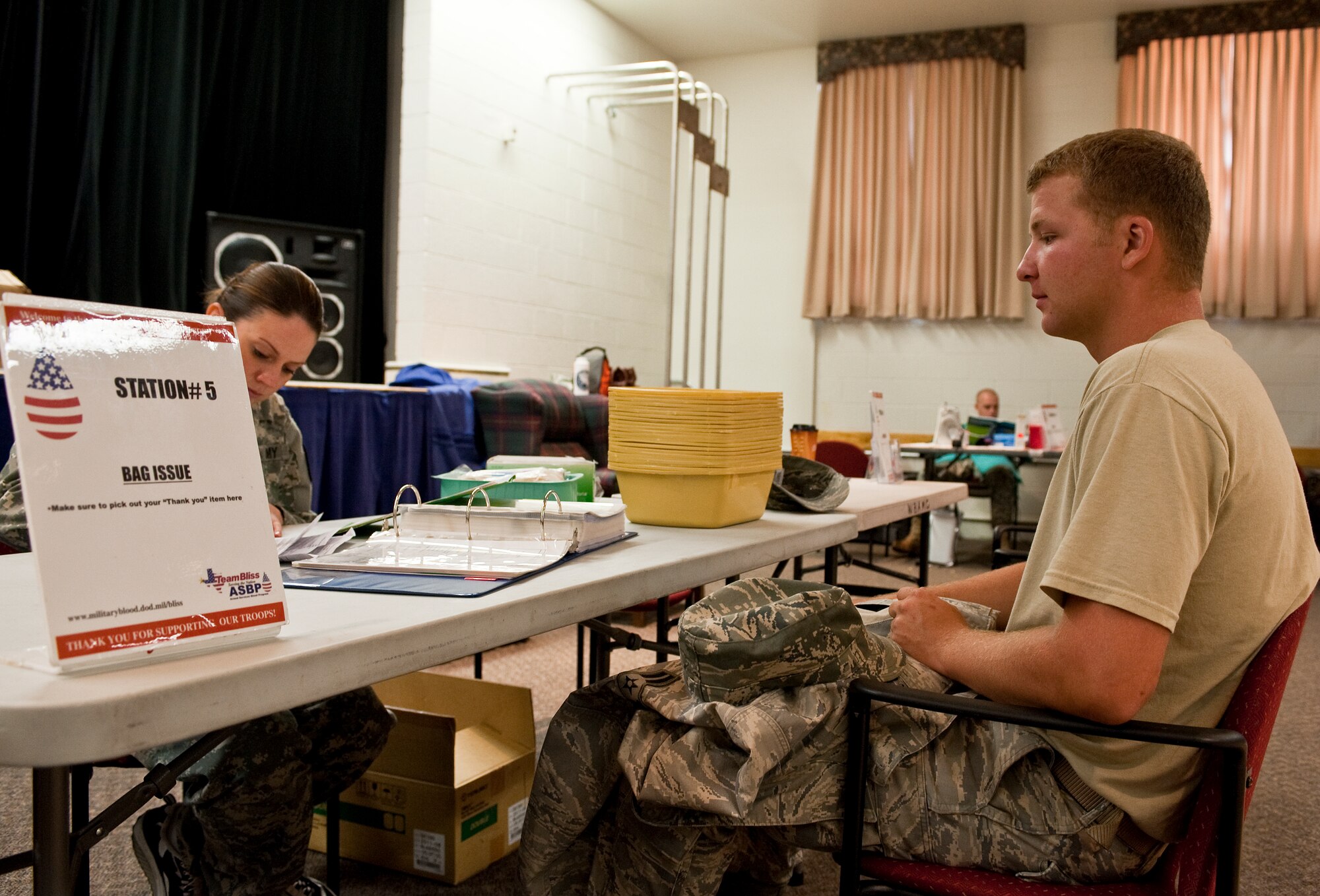 HOLLOMAN AIR FORCE BASE, N.M. -- Airman 1st Class Jacob Shoff, 49th Civil Engineer Squadron, receives a final check on the donor information he provided before giving blood at the Armed Services Blood Drive June 7, 2010. Airman Shoff has donated blood eight times, but the latest donation is his first at Holloman. Blood donation is a common practice and promoted to the civilian and military populations through programs sponsored by the American Red Cross and Armed Services Blood Program. (U.S. Air Force photo by Senior Airman DeAndre Curtiss / Released)