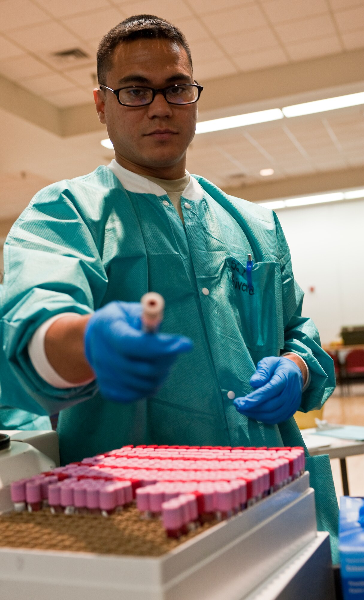 HOLLOMAN AIR FORCE BASE, N.M. -- U.S. Army Sgt. Luis Rivera, with the Armed Services Blood Program, inserts a vile of donated blood into a holder during a blood drive June 7, 2010. The ASBP provides blood products for service members and their families in both peacetime and war. As a joint operation among the military services the ASBP has many components working together to collect, process, store, distribute and transfuse blood worldwide. (U.S. Air Force photo by Senior Airman DeAndre Curtiss / Released) 