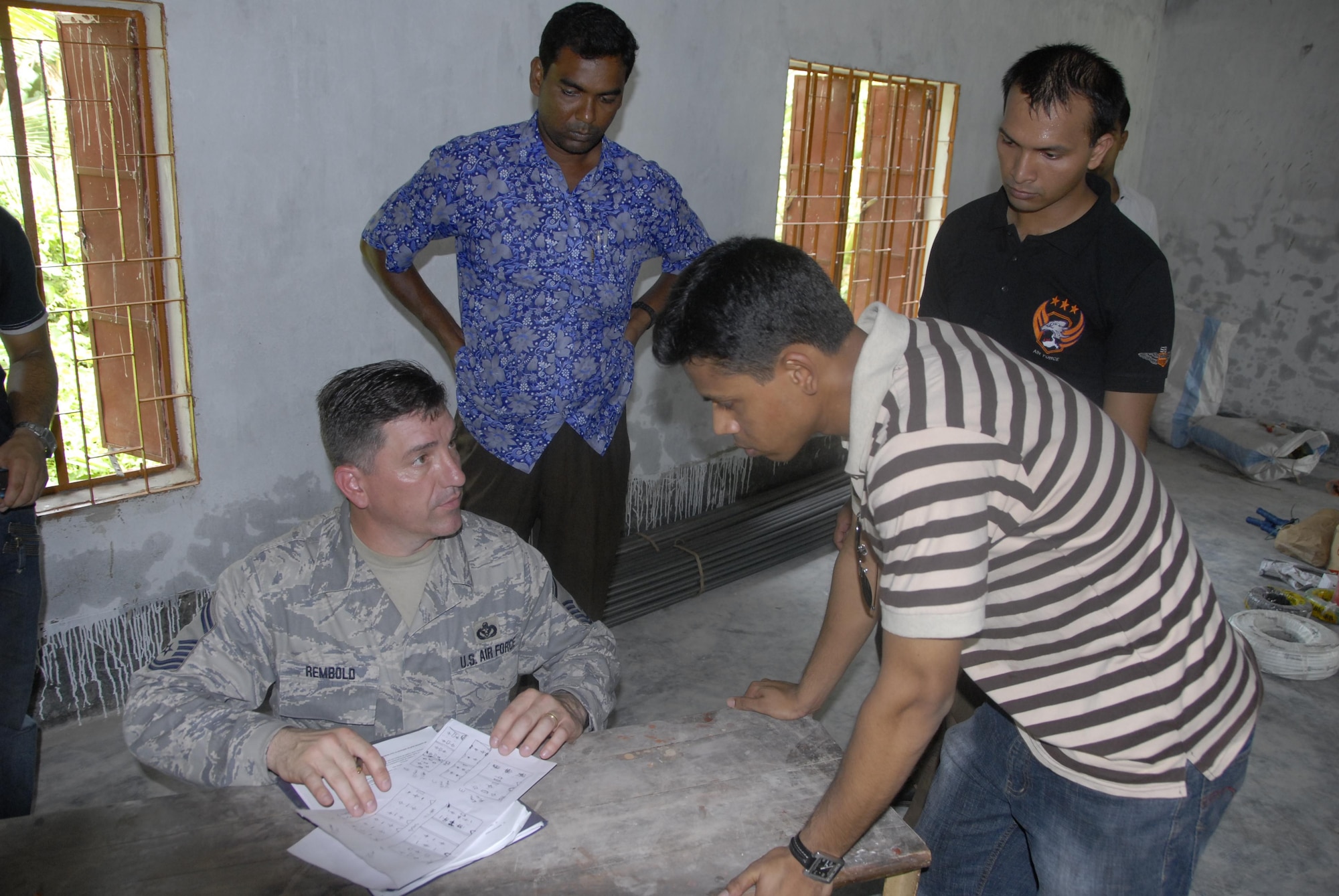 Senior Master Sgt. Terry Rembold (left), a civil engineer from the 354th Civil Engineer Squadron at Eielson Air Force Base, Alaska, explains construction plans to a member of the Bangladesh Air Force June 10 in preparation for Operation Pacific Angel in Bangladesh, scheduled for June 12 through 16, 2010. Operation Pacific Angel is a joint and combined humanitarian assistance operation conducted in the Pacific area of responsibility to support U.S. Pacific Command's capacity-building efforts. This humanitarian and civic assistance program is aimed at improving military civic cooperation between the United States and countries throughout the Asia-Pacific region.  More than 55 U.S. military personnel will participate in civil and medical assistance programs with the help of the Bangladesh Air Force and local nongovernmental organizations.  (U.S. Air Force photo / 1st Lt. Chris Hoyler)