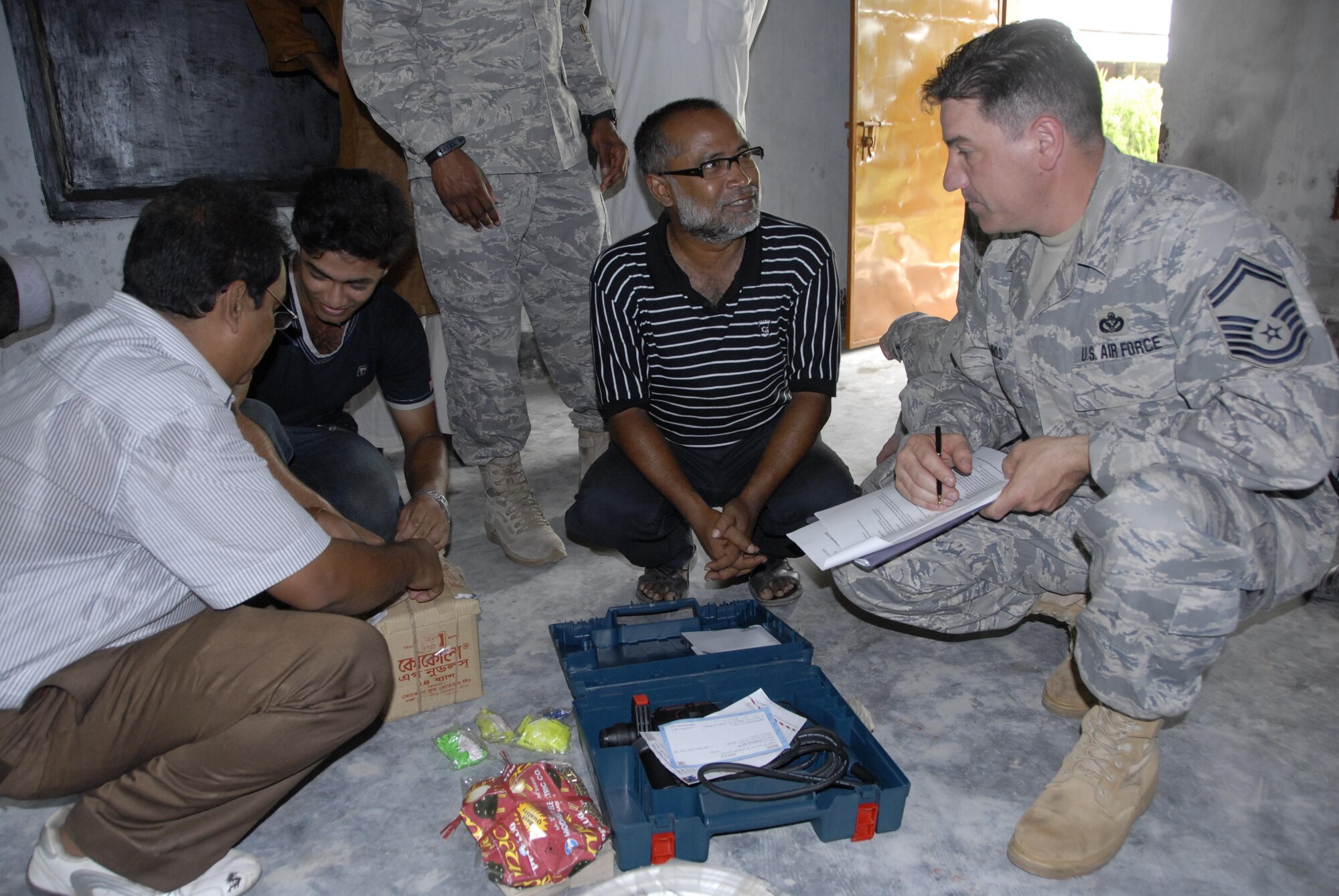 Senior Master Sgt. Terry Rembold (right), a civil engineer from the 354th Civil Engineer Squadron at Eielson Air Force Base, Alaska, discusses engineering plans with a Bangladeshi construction contractor on June 9, 2010 in preparation for the kick-off of Pacific Angel in Bangladesh scheduled to take place June 12 through 16, 2010. Operation Pacific Angel is a joint and combined humanitarian assistance operation conducted in the Pacific area of responsibility to support U.S. Pacific Command's capacity-building efforts. This humanitarian and civic assistance program is aimed at improving military civic cooperation between the United States and countries throughout the Asia-Pacific region.  More than 55 U.S. military personnel will participate in civil and medical assistance programs with the help of the Bangladesh Air Force and local nongovernmental organizations.  (U.S. Air Force photo / 1st Lt. Chris Hoyler)