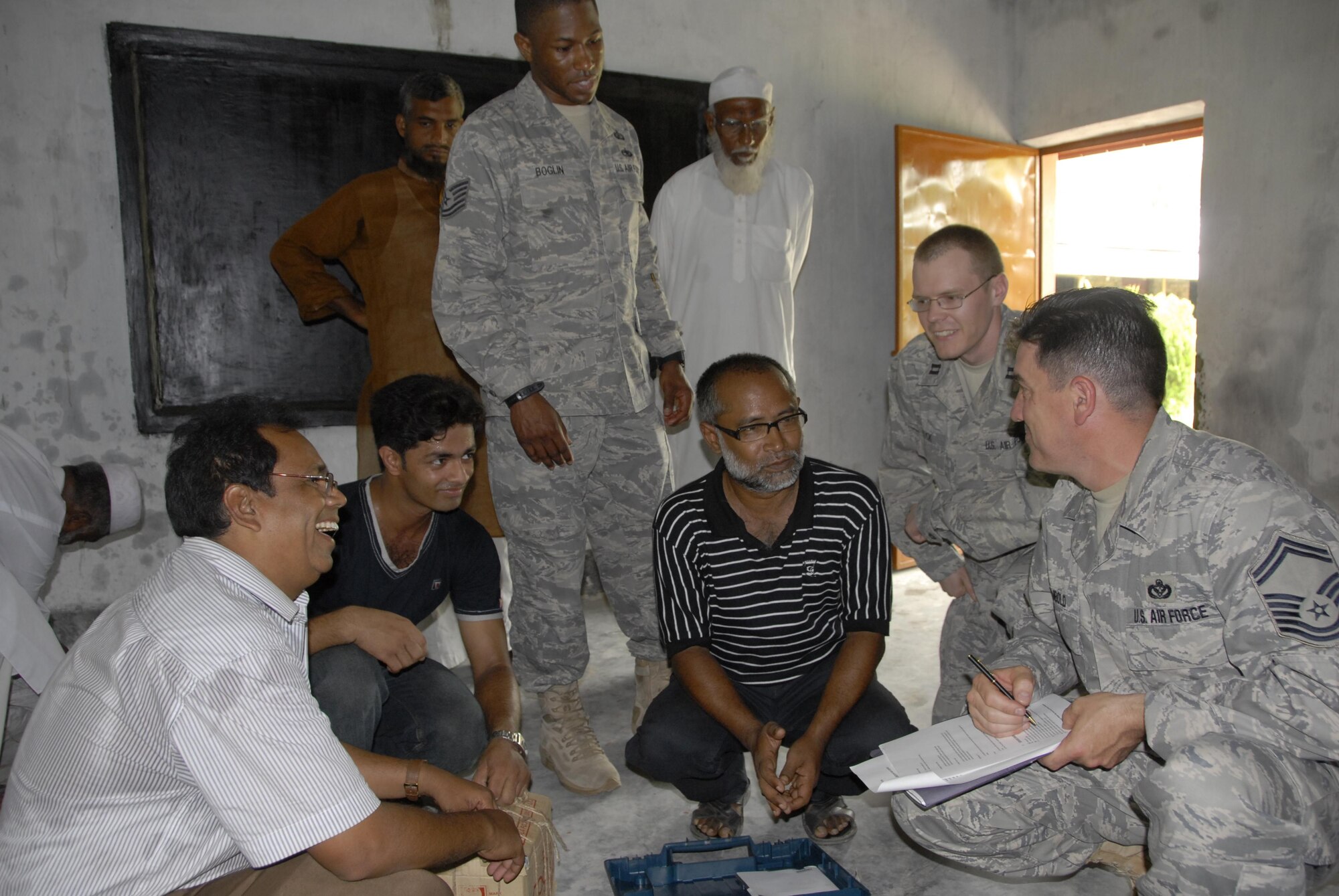 Tech. Sgt. Carlos Boglin (left),  Capt. David Masuck and Senior Master Sgt. Terry Rembold,  U.S. Air Force civil engineers participating in Operation Pacific Angel in Bangladesh, examine equipment and discuss engineering plans on June 9, 2010 with Bangladeshi locals in preparation for the kick-off of the humanitarian operation which is scheduled June 12 through 16. Operation Pacific Angel is a joint and combined humanitarian assistance operation conducted in the Pacific area of responsibility to support U.S. Pacific Command's capacity-building efforts. This humanitarian and civic assistance program is aimed at improving military civic cooperation between the United States and countries throughout the Asia-Pacific region.  More than 55 U.S. military personnel will participate in civil and medical assistance programs with the help of the Bangladesh Air Force and local nongovernmental organizations.  (U.S. Air Force photo / 1st Lt. Chris Hoyler)