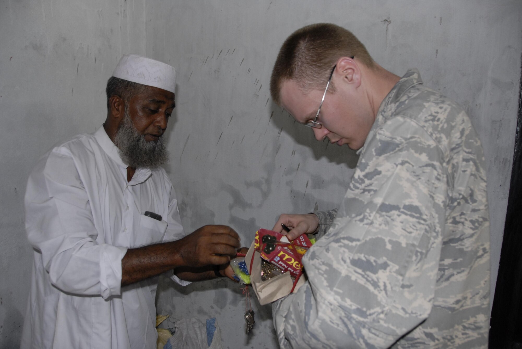 Capt. David Masuck (right), a civil engineer from 354th Civil Engineer Squadron at Eielson Air Force Base, Alaska, examines items to be used during engineering projects as part of Operation Pacific in Bangladesh, on June 9, 2010.  Operation Pacific Angel is a joint and combined humanitarian assistance operation conducted in the Pacific area of responsibility to support U.S. Pacific Command's capacity-building efforts. This humanitarian and civic assistance program is aimed at improving military civic cooperation between the United States and countries throughout the Asia-Pacific region. More than 15 structural, plumbing and electrical civil engineers will do construction work at a school in Jessore, Bangladesh.  Operation Pacific Angel is scheduled through June 16, 2010. (U.S. Air Force photo / 1st Lt. Chris Hoyler)