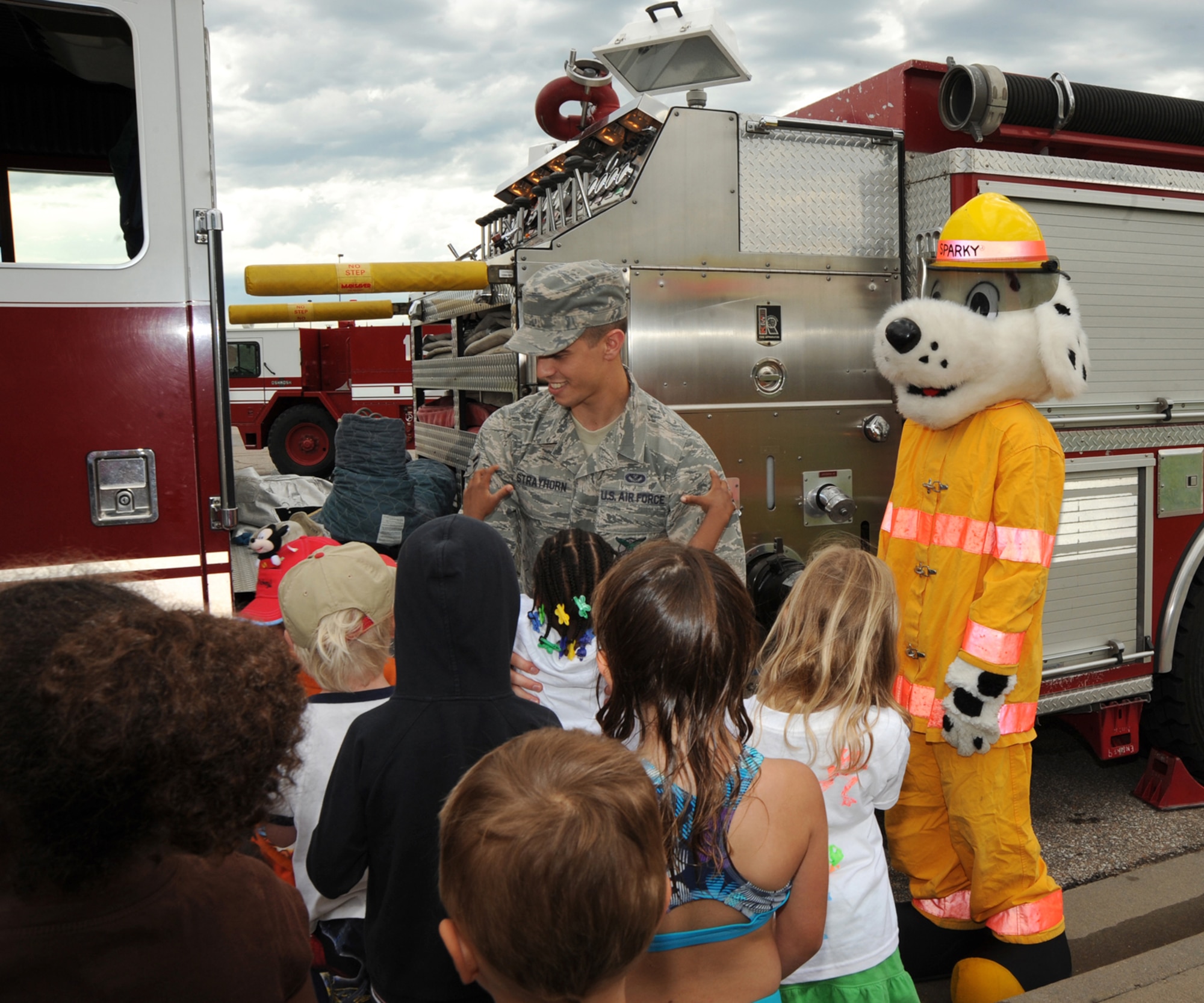 Airman 1st Class Aaron Strayhorn, 22nd Civil Engineering Squadron firefighter, provides a tour of a fire truck to children of Team McConnell’s summer reading program, June 7, 2010, McConnell Air Force Base, Kan.  The firefighters participated with the base library to help kick off the 2010 Summer Reading Program, allowing the children to familiarize themselves with the fire truck while playing with water sprayed from one of the trucks’ provided.  This summer’s theme is “Splash Down” and features water-related books and activities. (U.S. Air Force photo/Airman 1st Class Andrea Salazar)