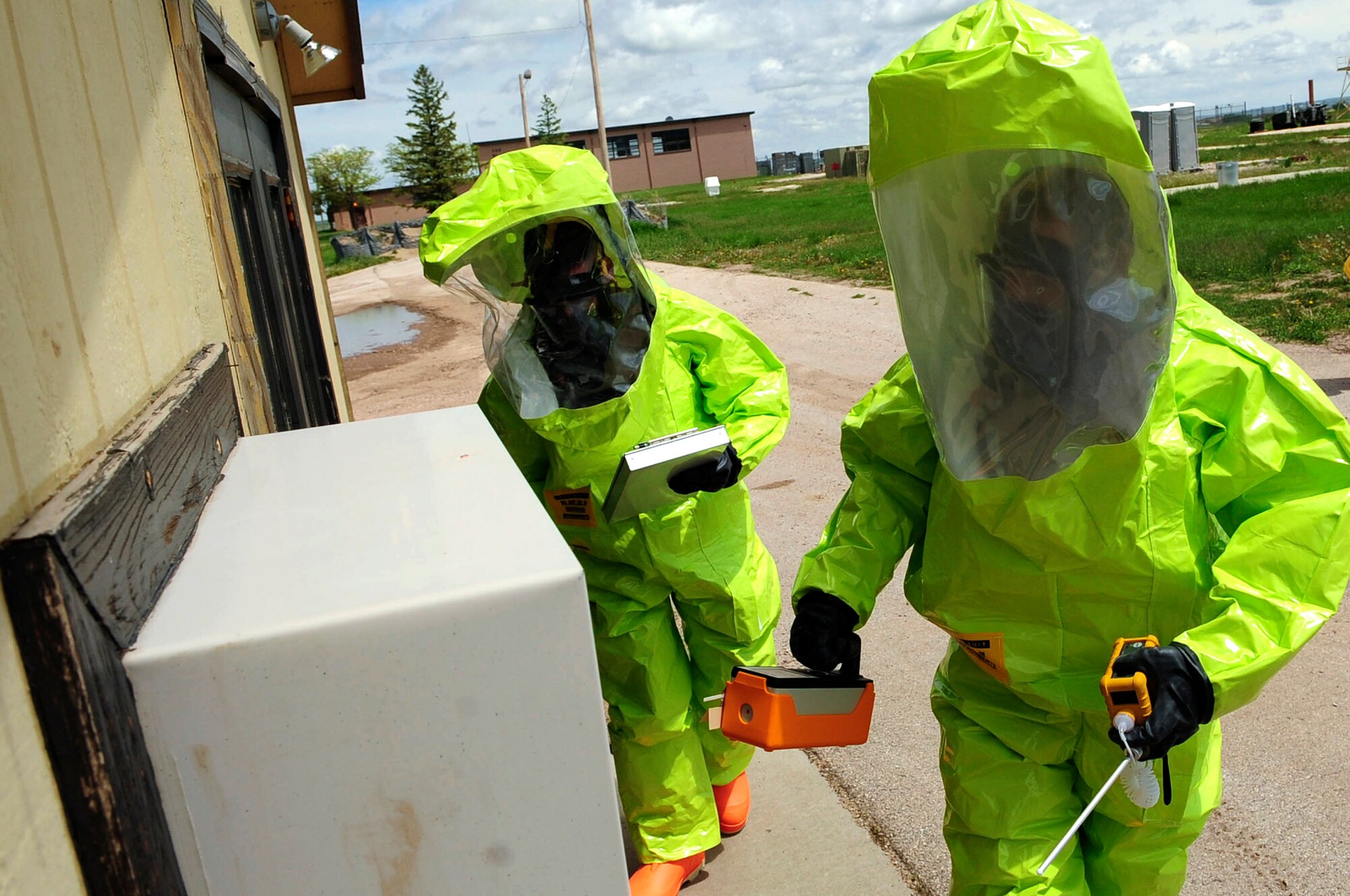 Airmen 1st Class David Jack (right) and Matthew Hung participate in an emergency management exercise, June 3, 2010, at Ellsworth Air Force Base, S.D. Both Airmen are 28th Civil Engineer Squadron emergency management journeymen, and perform chemical, biological, radiological and nuclear detection and decontamination operations. (U.S. Air Force photo/Airman 1st Class Corey Hook)
