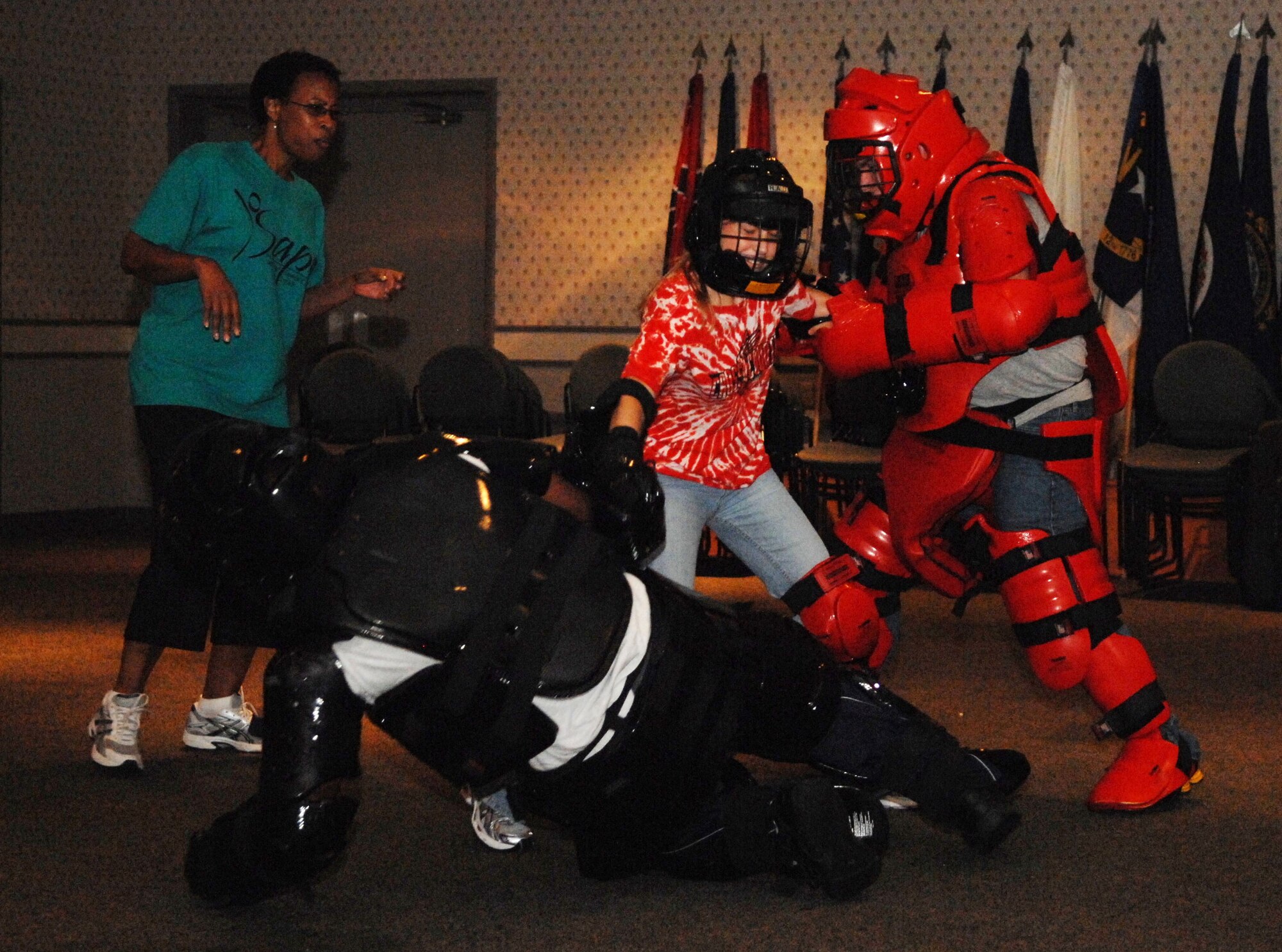 SCOTT AIR FORCE BASE, Ill. -- Kate Brien, a 17-year-old dependent, fights off two aggressors during a simulated attack as Pamela Dorsey, Sexual Assault Response Coordinator, supervises during a Rape Aggression Defense class June 5. The class was open only to women ages 12 and up. (U.S. Air Force photo by Senior Airman Samantha S. Crane)  