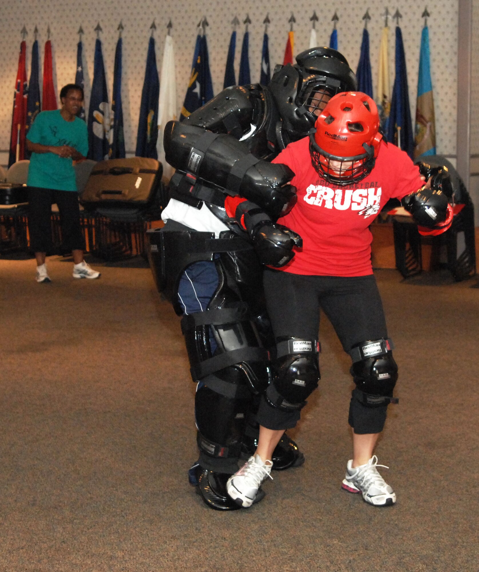 SCOTT AIR FORCE BASE, Ill. -- Vanessa Fargo, 375th Civil Engineer Squadron water programs manager, fights off an aggressor during a simulated attack as Pamela Dorsey, Sexual Assault Response Coordinator, supervises during a Rape Aggression Defense class June 5. The scenarios gave participants the chance to practice the new self defense techniques they learned earlier in the day. (U.S. Air Force photo by Senior Airman Samantha S. Crane)  