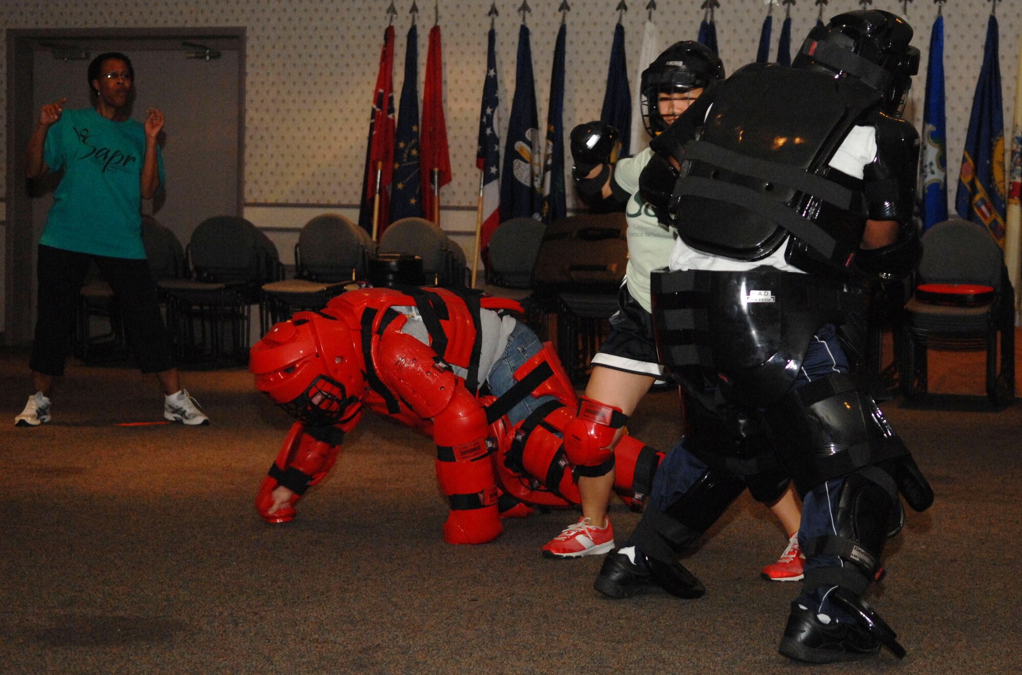 SCOTT AIR FORCE BASE, Ill. -- Alanna Nacar, a 17-year-old dependent, fights off two aggressors during a simulated attack as Pamela Dorsey, Sexual Assault Response Coordinator, supervises during a Rape Aggression Defense class June 5. The free class was hosted by Ms. Dorsey and the Southwestern Illinois College Department of Public Safety. (U.S. Air Force photo by Senior Airman Samantha S. Crane)  