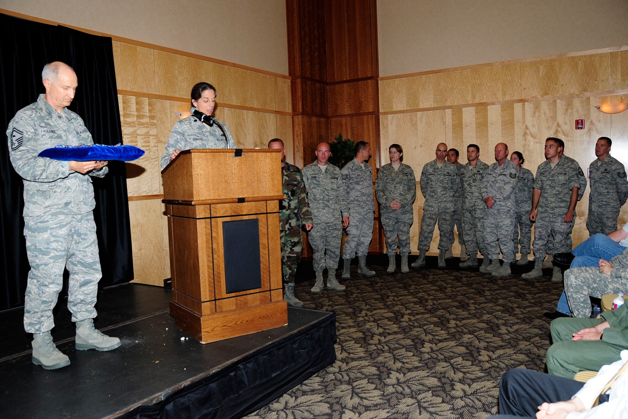 Lt. Col. Melani Howard, 67th Aerial Port Squadron commander, addresses Airmen at Hill Air Force Base’s monthly Warrior Call June 4. Colonel Howard presented the Humanitarian Service Medal to 15 reservists from her unit who voluntarily deployed to Haiti in the aftermath of the nation’s devastating earthquake earlier this year. The Airmen were deployed for about five weeks and helped restore airfield operations in Port-au-Prince. (U.S. Air Force photo/Kimberly Cook) 