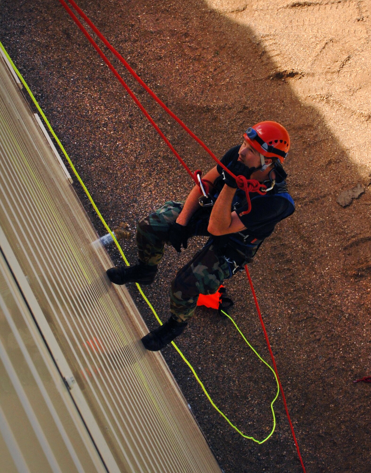 MINOT AIR FORCE BASE, N.D. -- Airman 1st Class Daniel Payne, 5th Civil Engineer Squadron firefighter, repels down the base’s new fire training facility during the ribbon cutting ceremony here June 7. The firefighters performed a pick off rescue demonstration as part of the dedication ceremony for the new facility. (U.S. Air Force photo by Airman 1st Class Aaron-Forrest Wainwright)