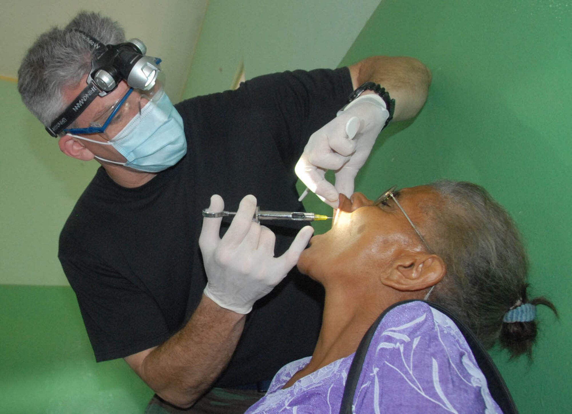 Lt. Col. (Dr.) Dave Doroff, a dentist with the 934th Aeromedical Staging Squadron, Minneapolis-St. Paul Air Reserve Station, Minn., injects a Dominican patient in preparation to extract a tooth during MEDRETE 2010 Dominican Republic. (U.S. Air Force photo/Master Sgt. Chance Babin)
