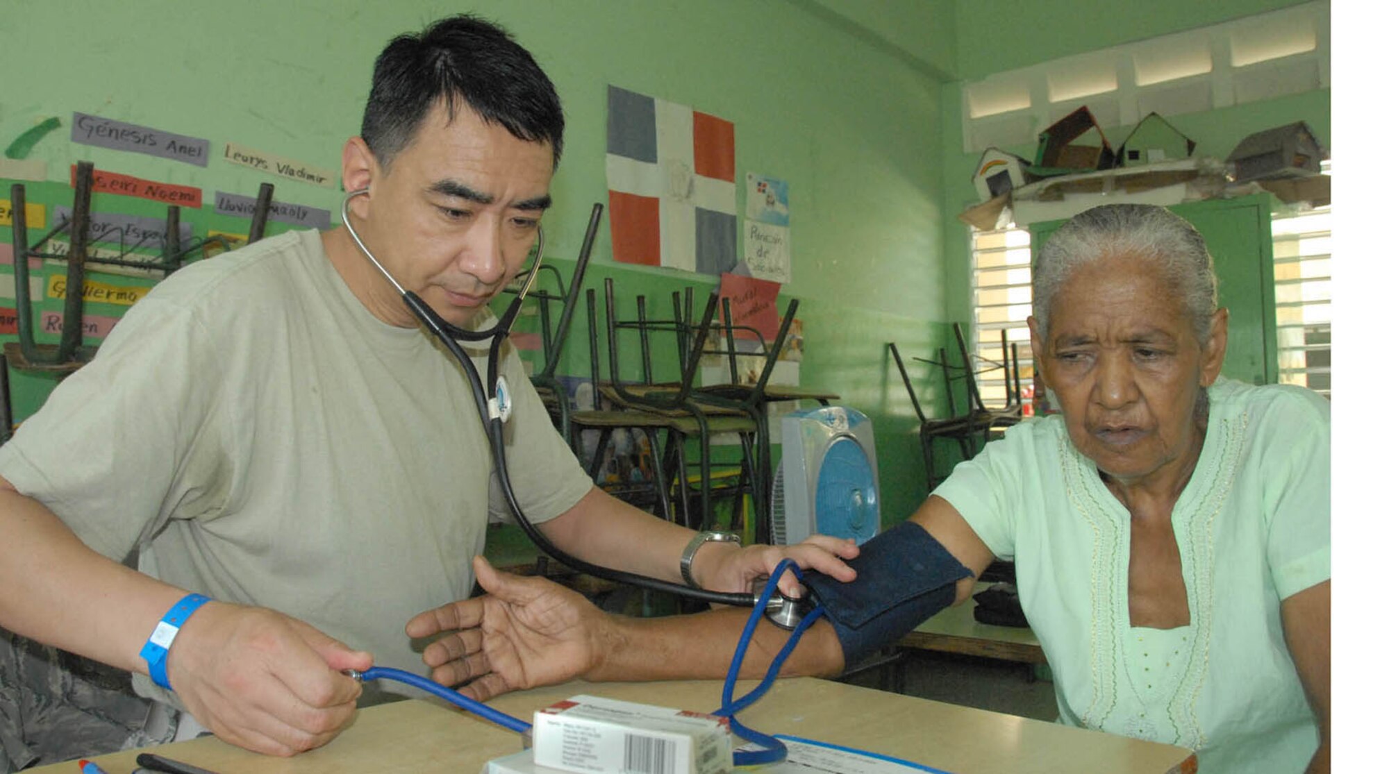 Maj. (Dr.) Pen Hau, a physician with the 62nd Medical Squadron,Joint Base Lewis-McChord, Wash., checks an elderly patient's blood pressure during MEDRETE 2010 Dominican Republic. The team of 39 medical specialist saw 7,500 patients at four different schools in the Puerto Plata region over a two-week period. (Air Force photo/Master Sgt. Chance Babin)