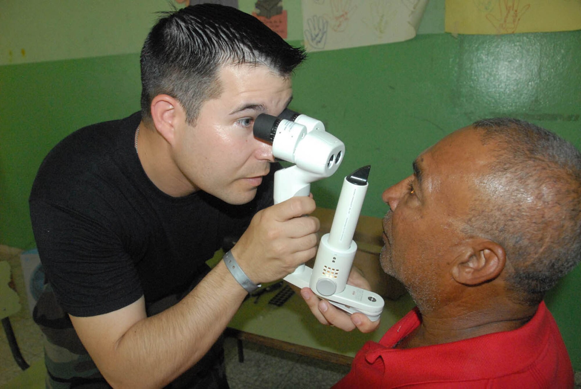 Capt. (Dr.) James Barnett, an optometrist with the 934th Aeromedical Staging Squadron, Minneapolis-St. Paul Air Reserve Station, Minn., performs and eye exam on a Dominican man during MEDRETE 2010 Dominican Republic. (U.S. Air Force photo/Master Sgt. Chance Babin)