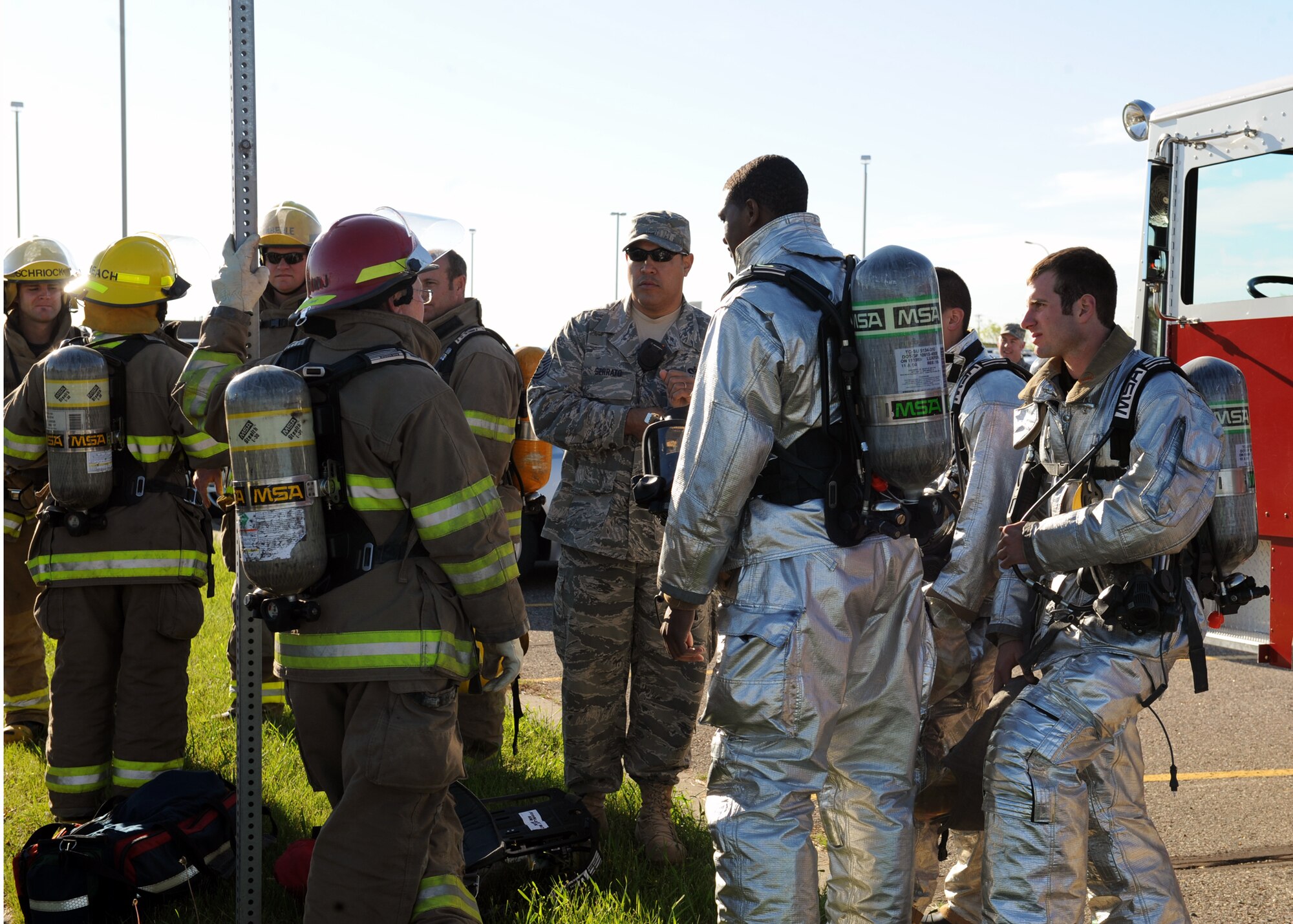 MINOT, N.D. -- Members of the Minot Fire Department and Minot AFB Fire Department discuss a course of action for entering the airport during the major accident response exercise at Minot International Airport here June 4. The airport is required to conduct a full-scale exercise once every three years. (U.S. Air Force photo by Staff Sgt. Keith Ballard)