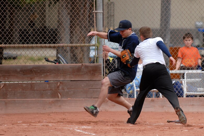 VANDENBERG AIR FORCE BASE, Calif. --  Patrick Clower, a 381st Training Support Squadron team member, tags out Carl Billardo, a 533rd Training Squadron team member, at home plate during an intramural softball game at the base field here Monday, June 7, 2010.  The 533rd TRS team scored 31 runs winning the game.  (U.S. Air Force photo/Senior Airman Andrew Satran) 

 
 
 

 
 