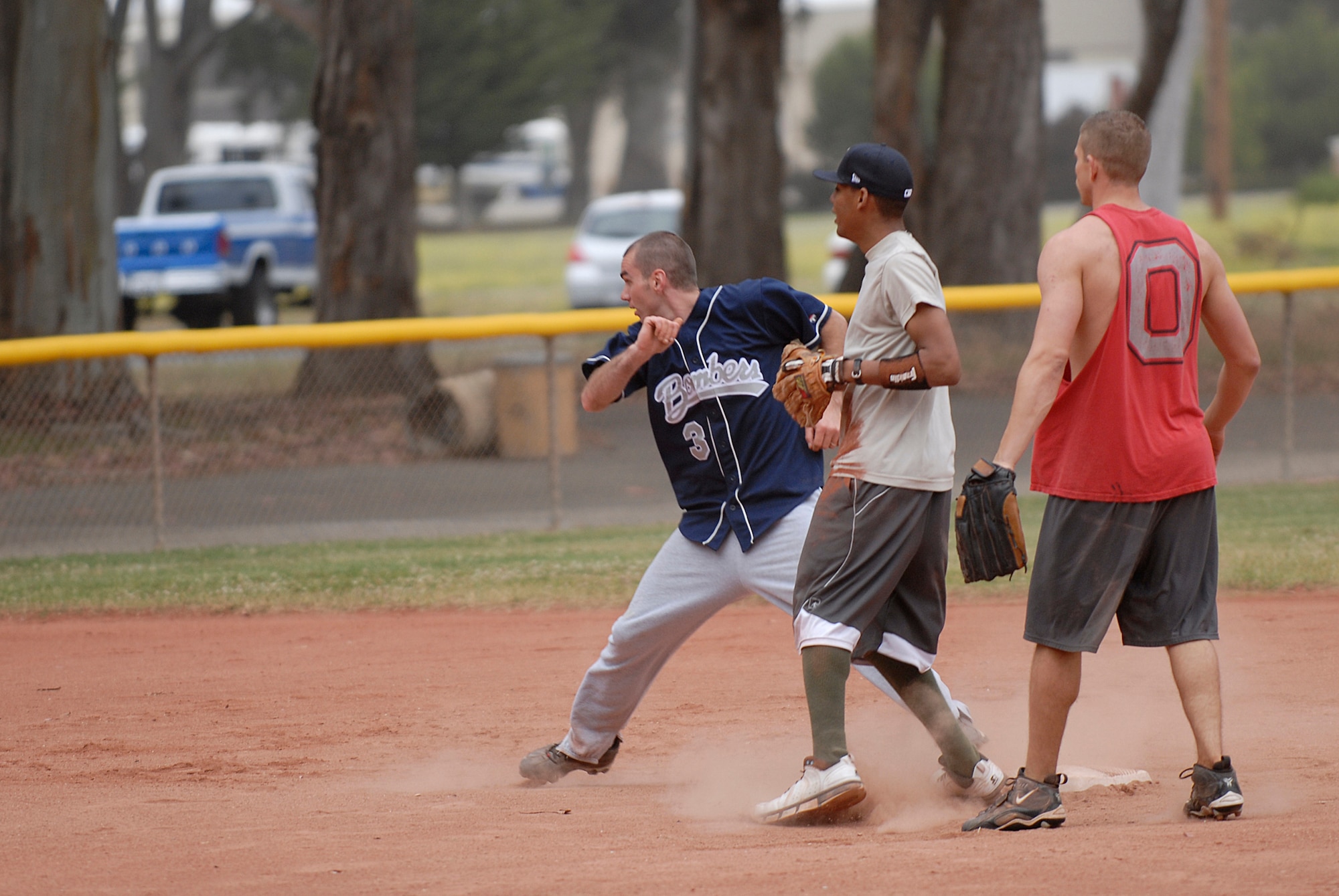 VANDENBERG AIR FORCE BASE, Calif. --  Running back to second base, Mark Sheetenhelm, a 533rd Training Squadron team member, tags the base during an intramural softball game at the base field here Monday, June 7, 2010.  The 533rd TRS won the game 31-2.  (U.S. Air Force photo/Senior Airman Andrew Satran) 

 
 
 

 
 