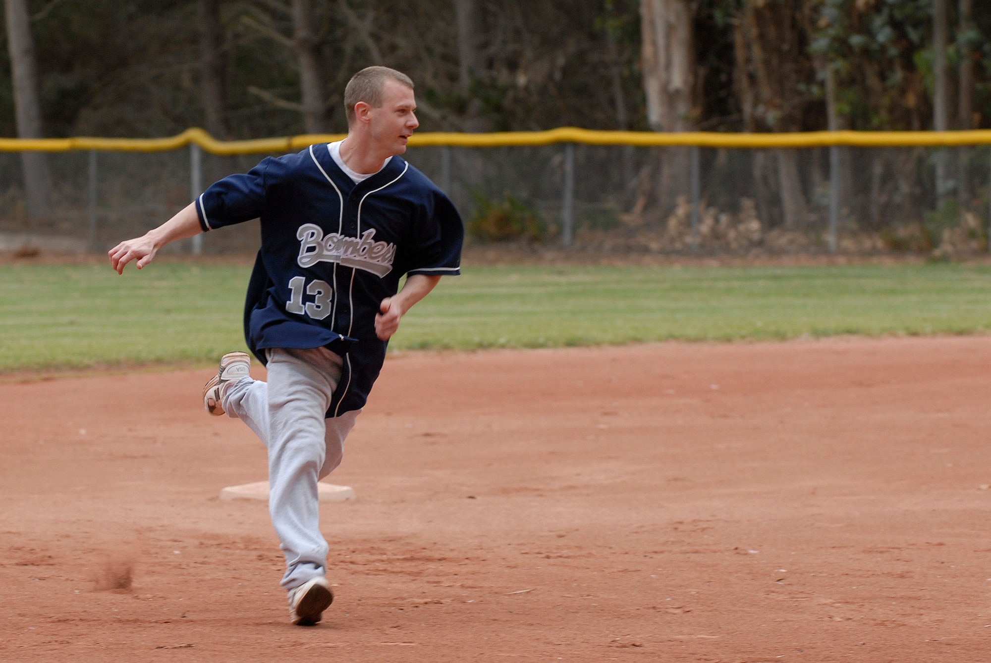 VANDENBERG AIR FORCE BASE, Calif. --  Running past second base, Chris Roberts, a 533rd Training Squadron team member, sprints to third base during an intramural softball game at the base field here Monday, June 7, 2010.  The 533rd TRS swept the 381st Training Support Squadron team 31-2.  (U.S. Air Force photo/Senior Airman Andrew Satran) 

 

 
 
